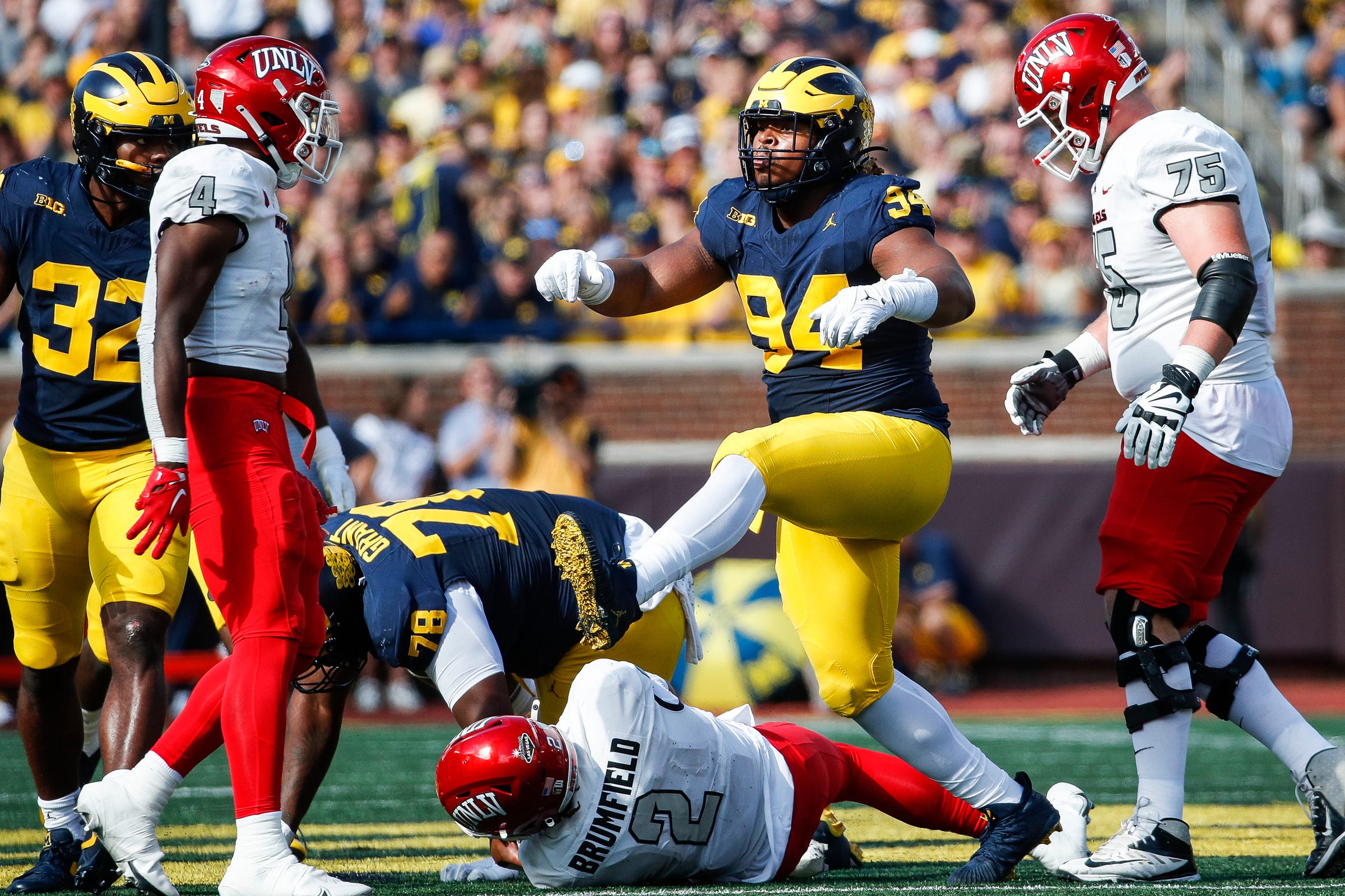 Michigan defensive lineman Kris Jenkins (94) celebrates a sack against UNLV quarterback Doug Brumfield (2) during the first half at Michigan Stadium in Ann Arbor on Saturday, Sept. 9, 2023.