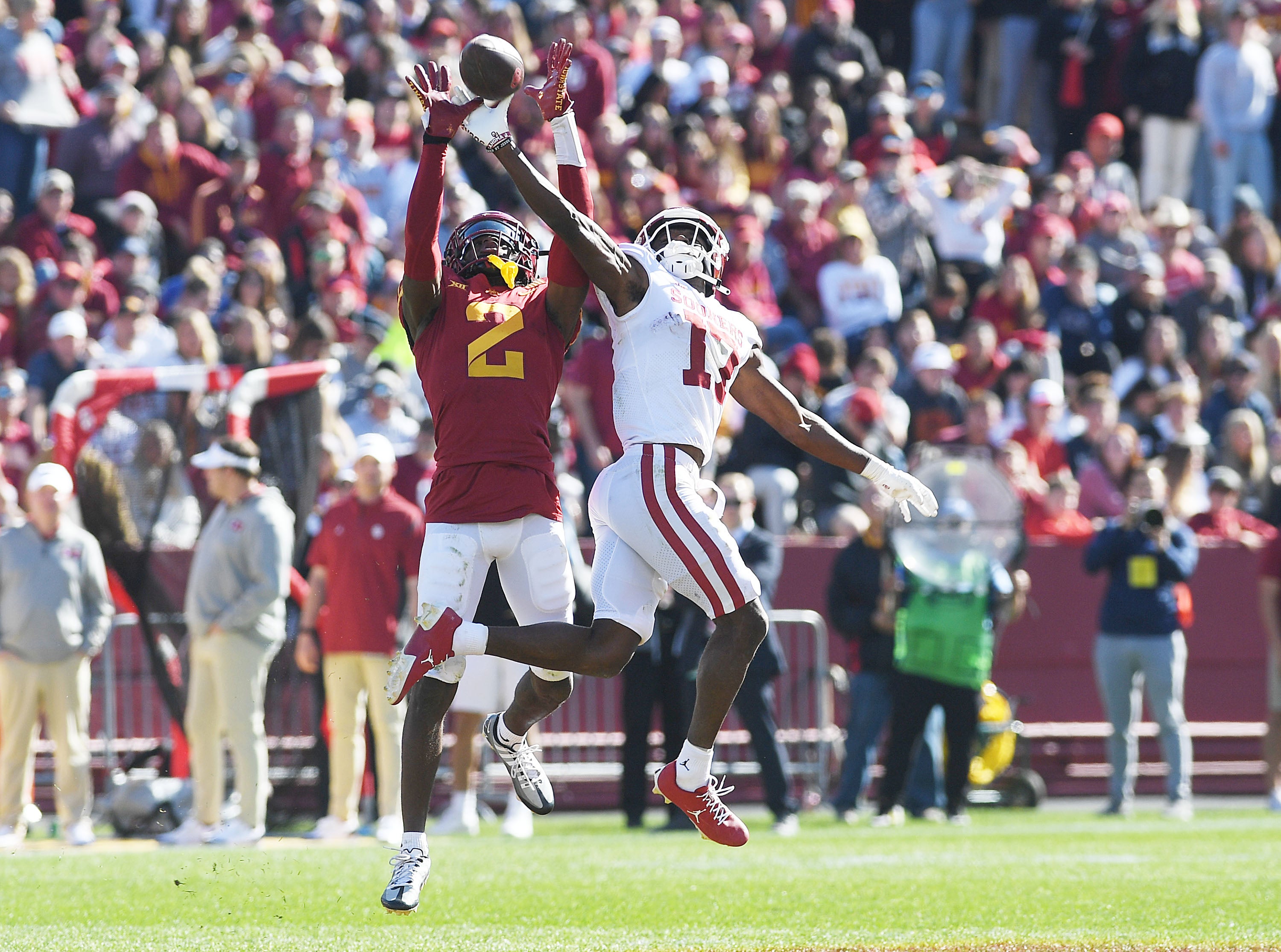 Oct 29, 2022; Ames, Iowa, USA; Iowa State Cyclones defensive back T.J. Tampa (2) knocks out the ball from from Oklahoma Sooners wide receiver Marvin Mims Jr. (17) during the third quarter in the Big 12 Conference game at Jack Trice Stadium.