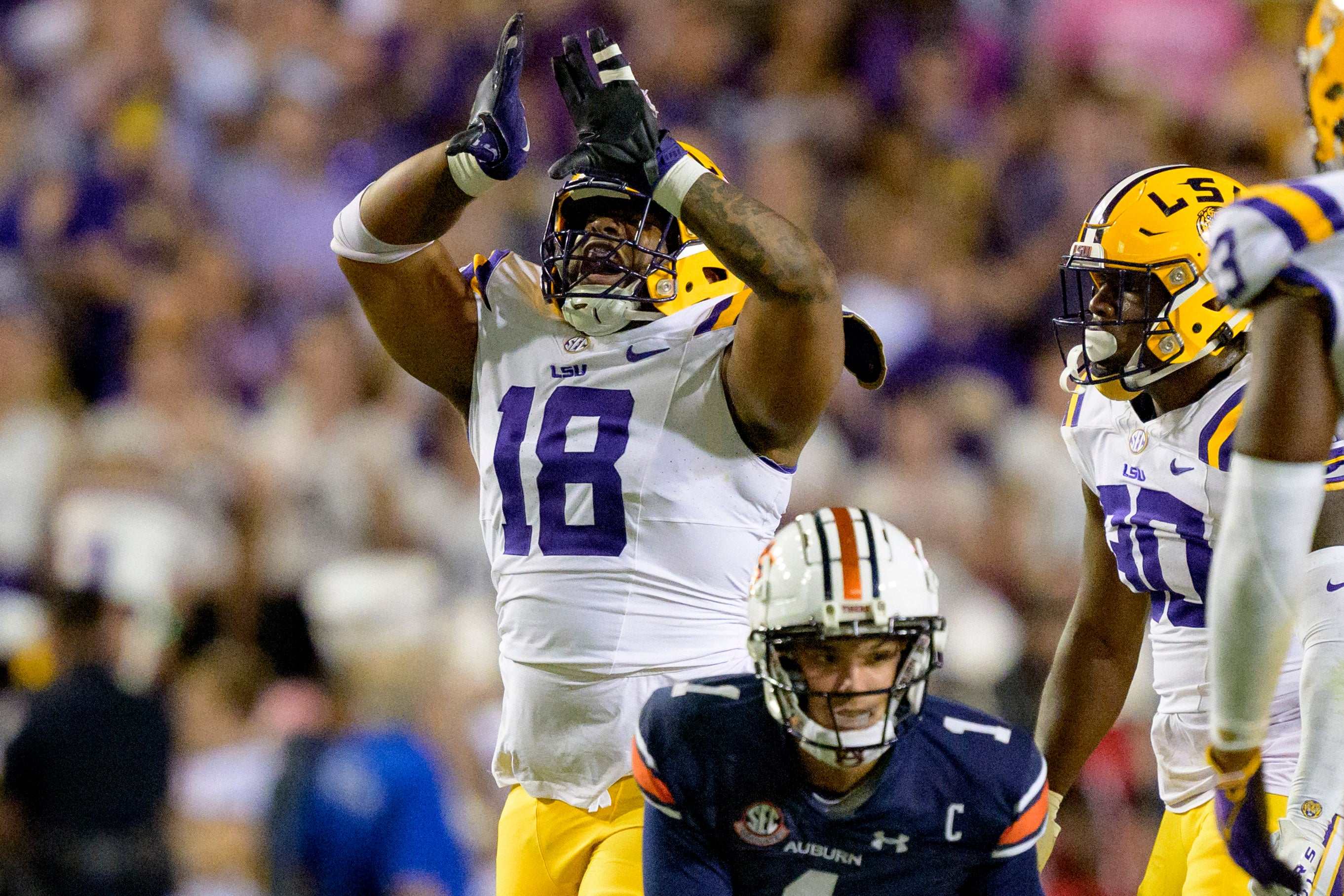 Oct 14, 2023; Baton Rouge, Louisiana, USA; LSU Tigers defensive tackle Mekhi Wingo (18) reacts after tackling Auburn Tigers quarterback Payton Thorne (1) during the second quarter at Tiger Stadium.