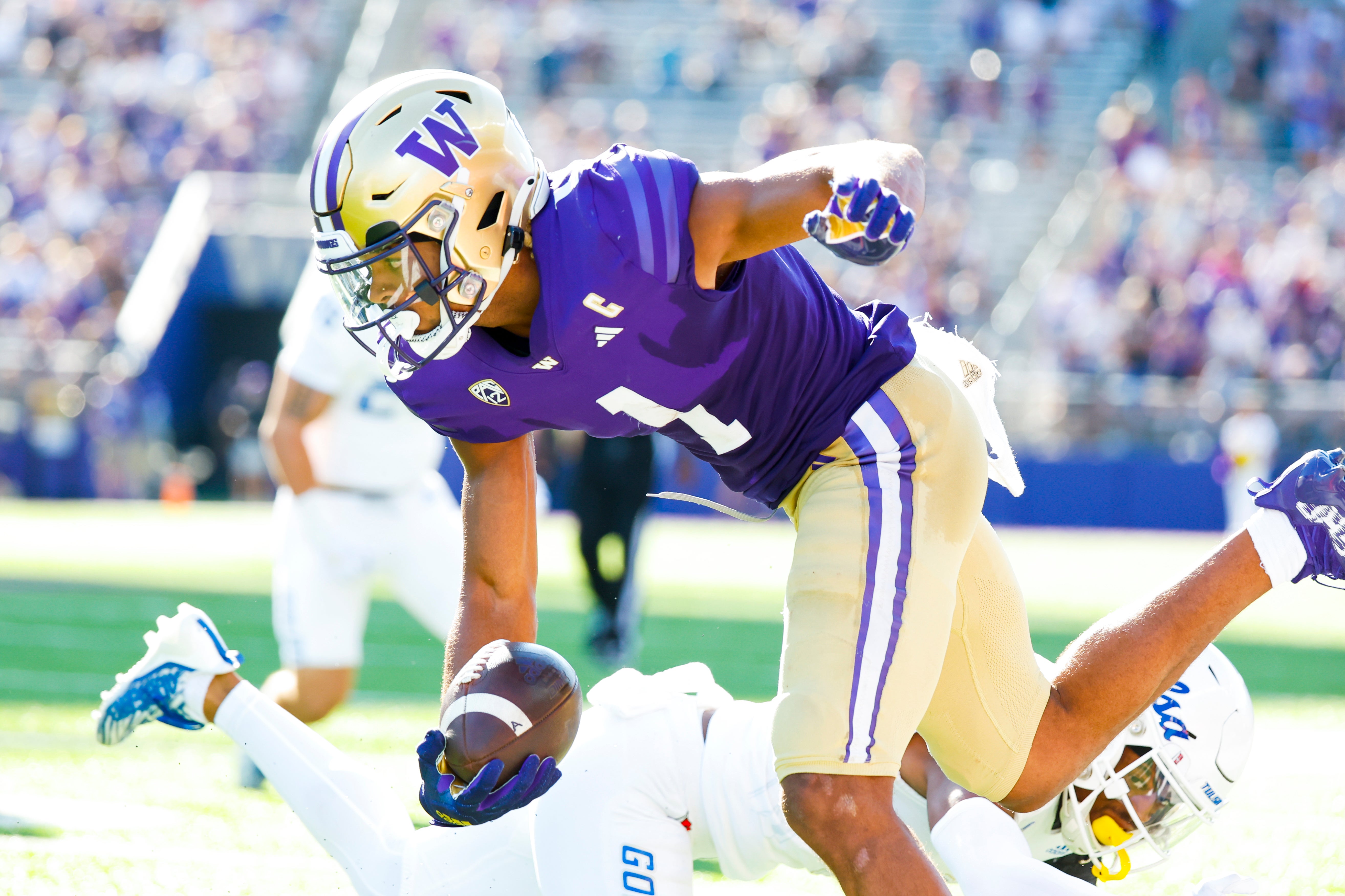 Sep 9, 2023; Seattle, Washington, USA; Washington Huskies wide receiver Rome Odunze (1) runs for yards after the catch against the Tulsa Golden Hurricane during the third quarter at Alaska Airlines Field at Husky Stadium.