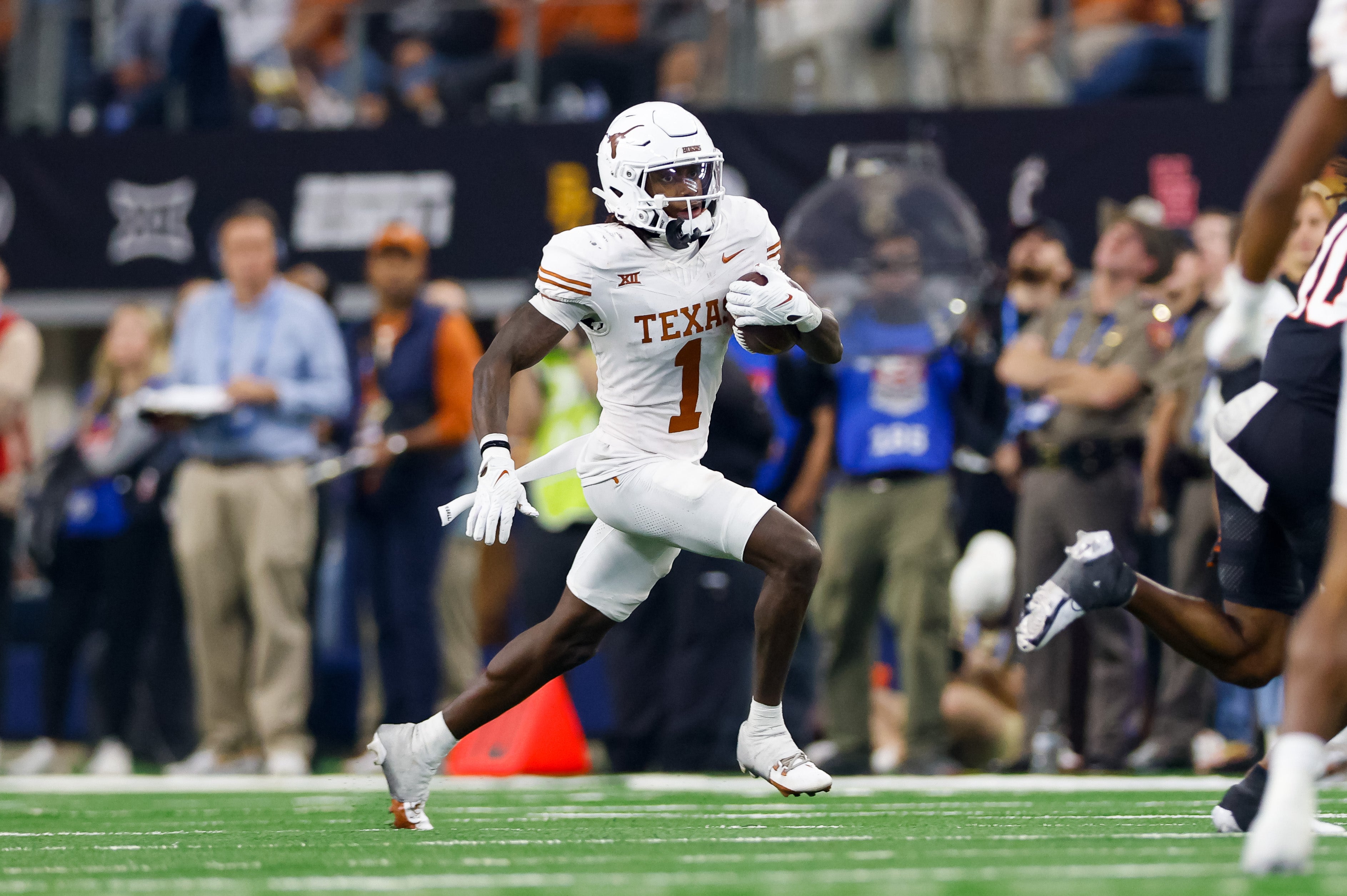 Dec 2, 2023; Arlington, TX, USA; Texas Longhorns wide receiver Xavier Worthy (1) runs with the ball against the Oklahoma State Cowboys during the fourth quarter at AT&T Stadium.