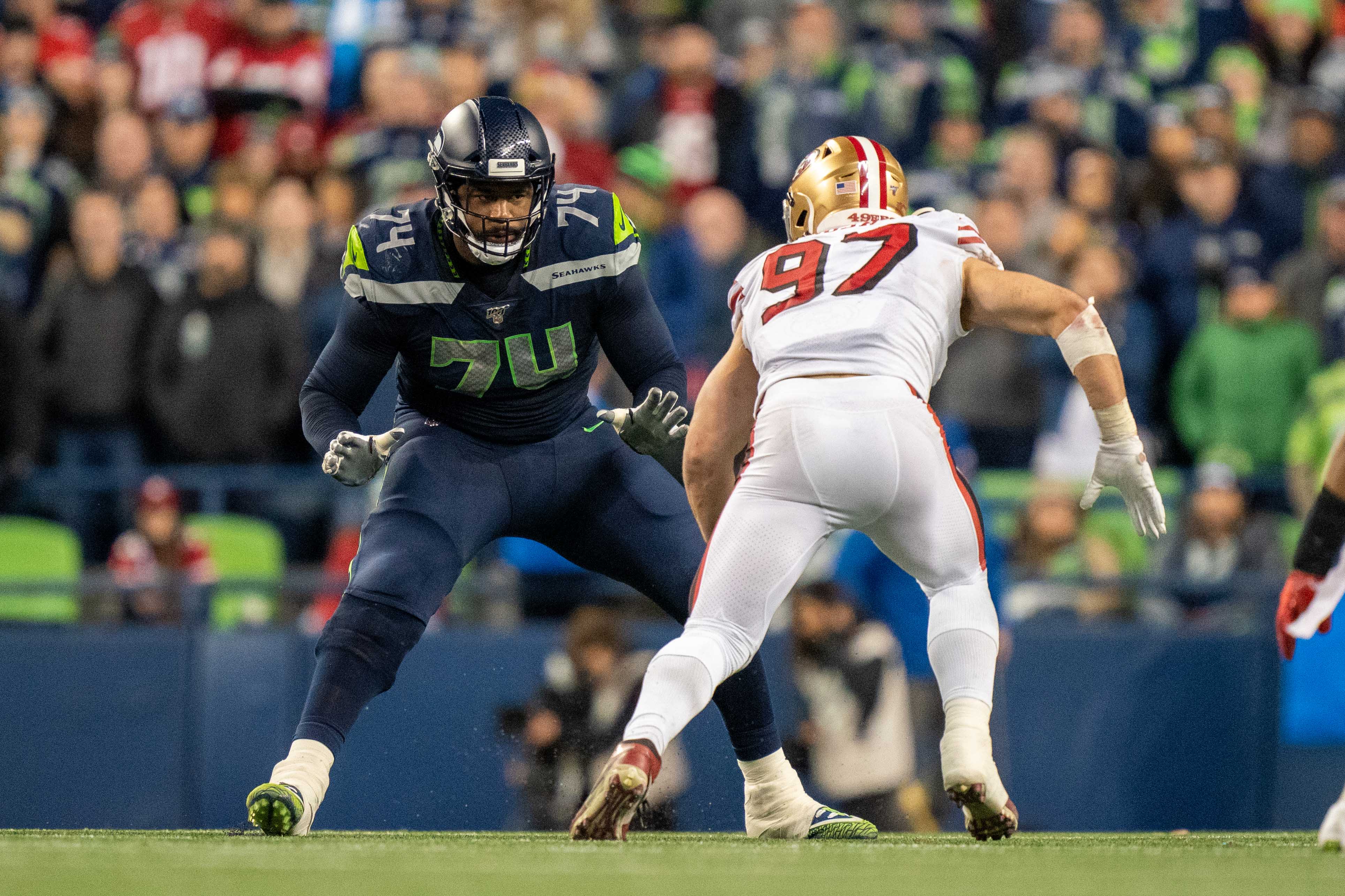 December 29, 2019; Seattle, Washington, USA; Seattle Seahawks offensive tackle George Fant (74) against San Francisco 49ers defensive end Nick Bosa (97) during the fourth quarter at CenturyLink Field.