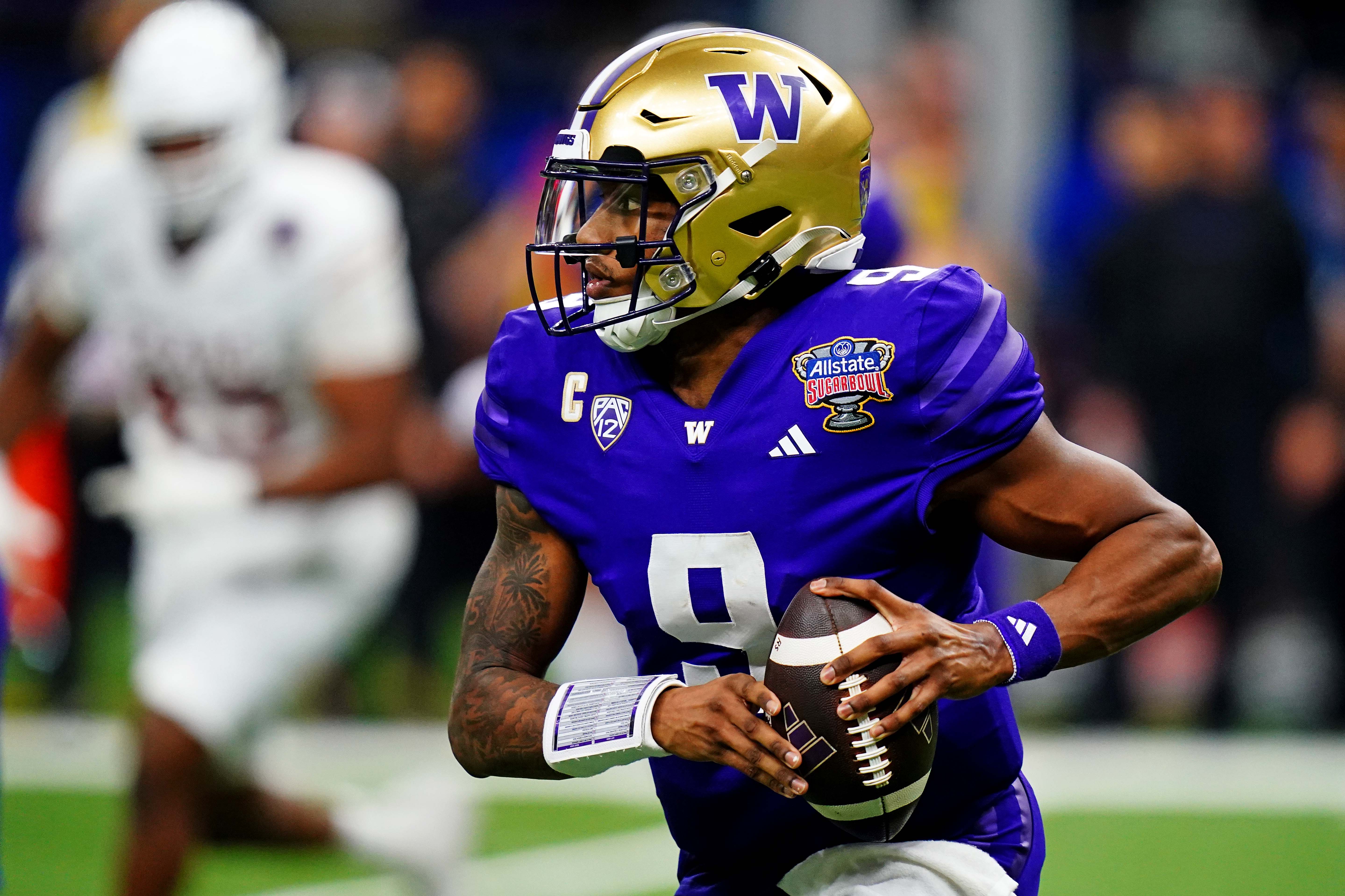 Jan 1, 2024; New Orleans, LA, USA; Washington Huskies quarterback Michael Penix Jr. (9) runs the ball during the fourth quarter against the Texas Longhorns in the 2024 Sugar Bowl college football playoff semifinal game at Caesars Superdome.