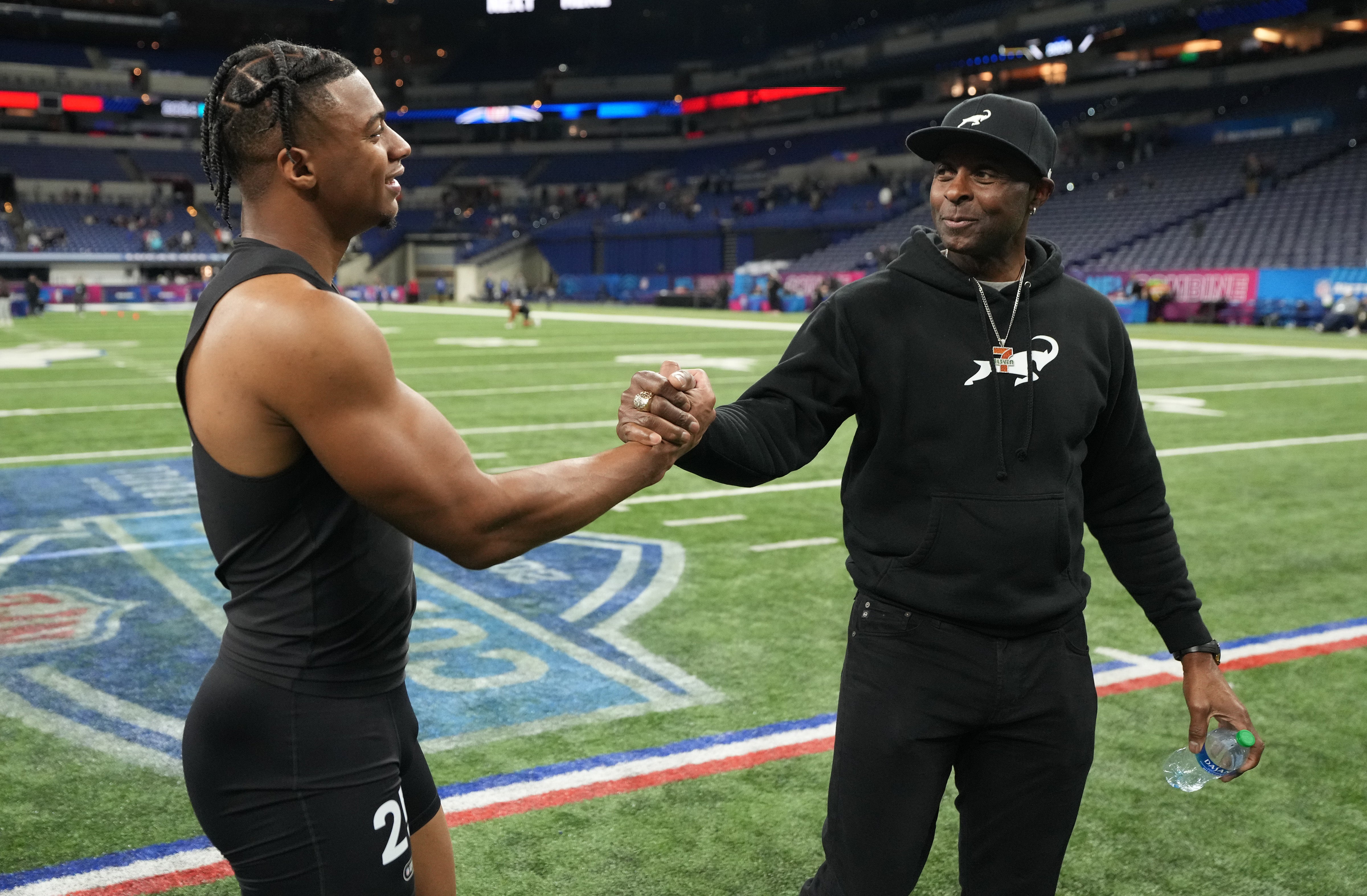 Mar 2, 2024; Indianapolis, IN, USA; Southern California wide receiver Brenden Rice (WO25) and his father, NFL Hall of Fame player Jerry Rice during the 2024 NFL Combine at Lucas Oil Stadium.