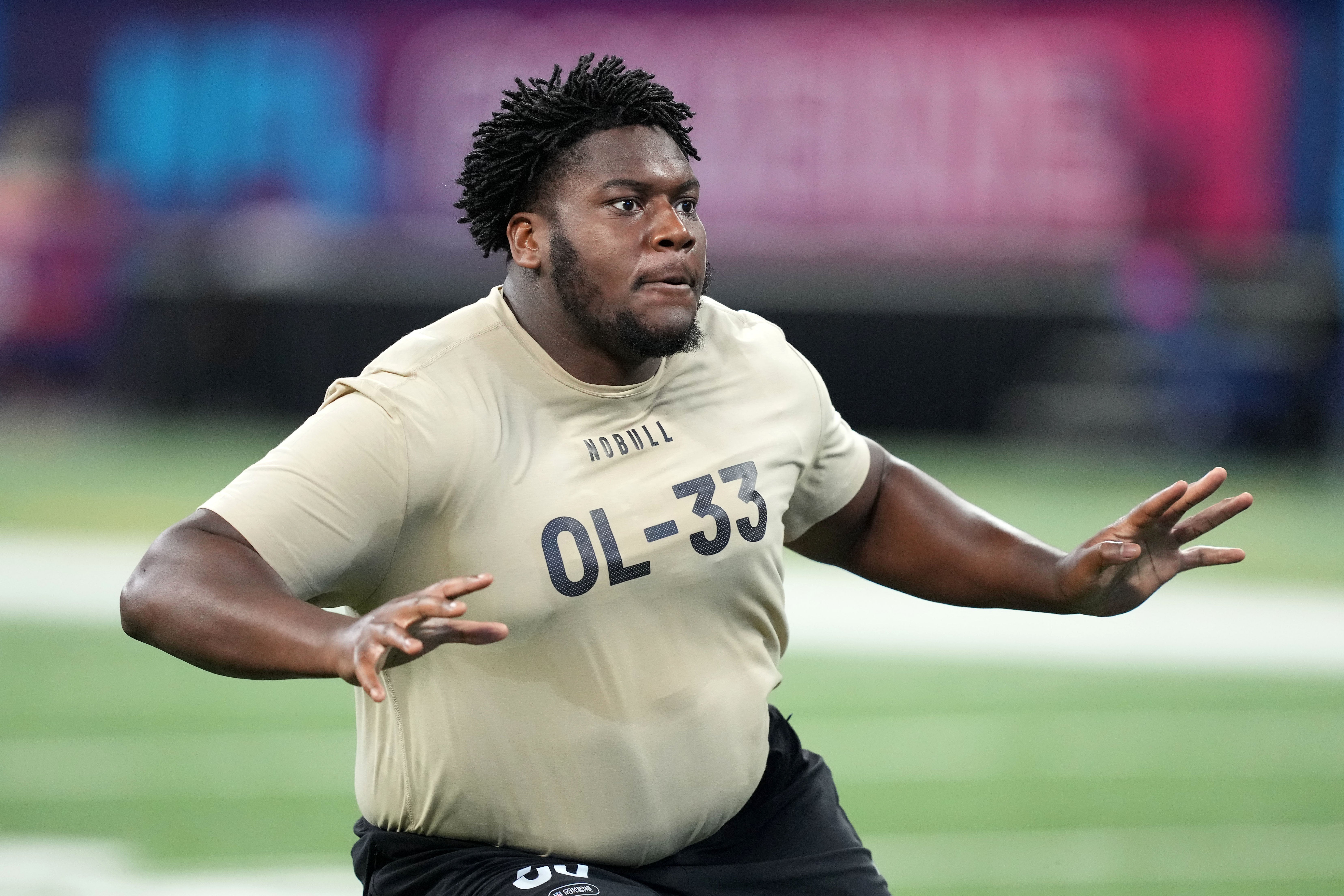 Mar 3, 2024; Indianapolis, IN, USA; Connecticut offensive lineman Christian Haynes (OL33) during the 2024 NFL Combine at Lucas Oil Stadium.