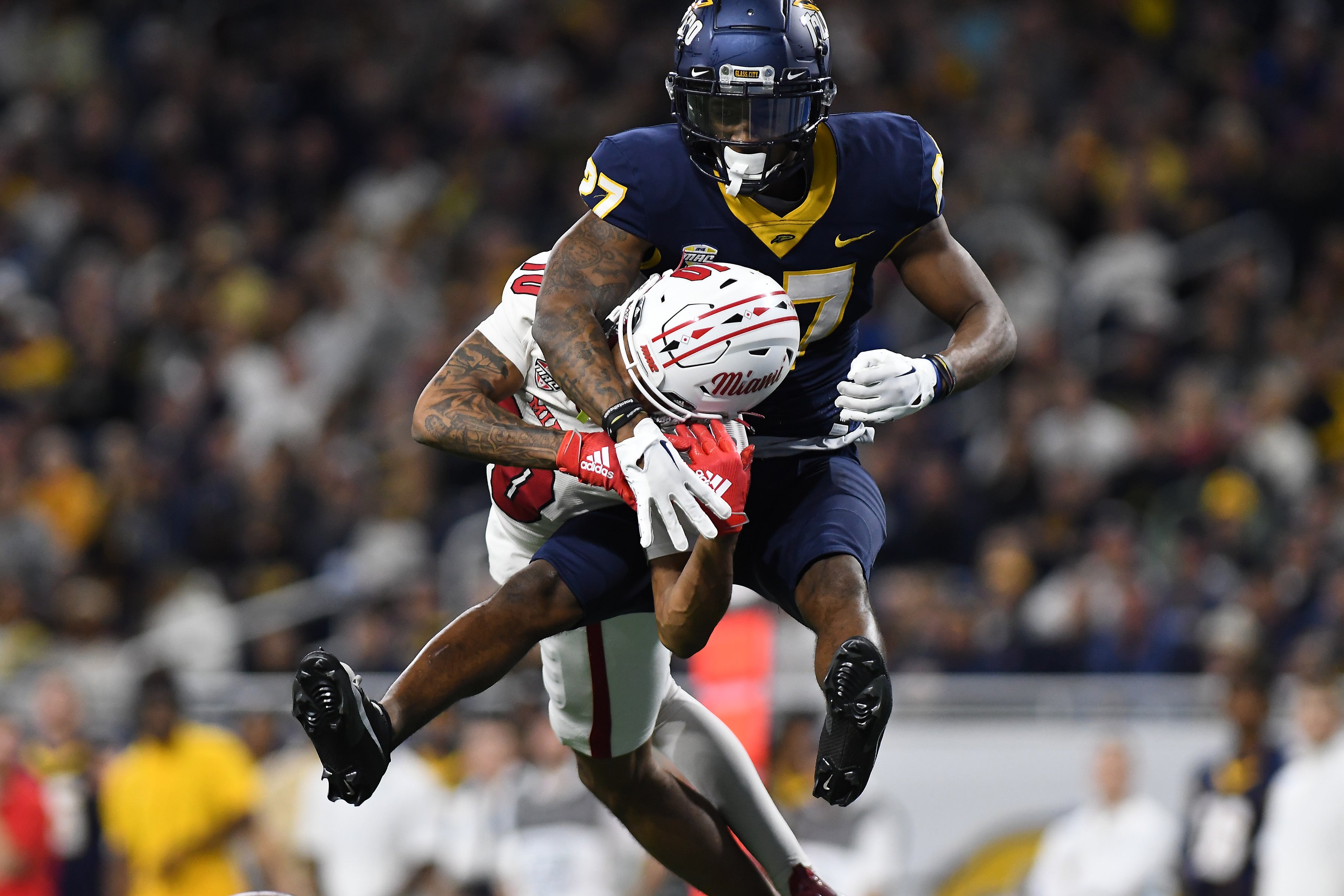 Dec 2, 2023; Detroit, MI, USA; Toledo Rockets cornerback Quinyon Mitchell (27) breaks up a pass intended for Miami (OH) Redhawks wide receiver Gage Larvadain (10) in the third quarter at Ford Field.