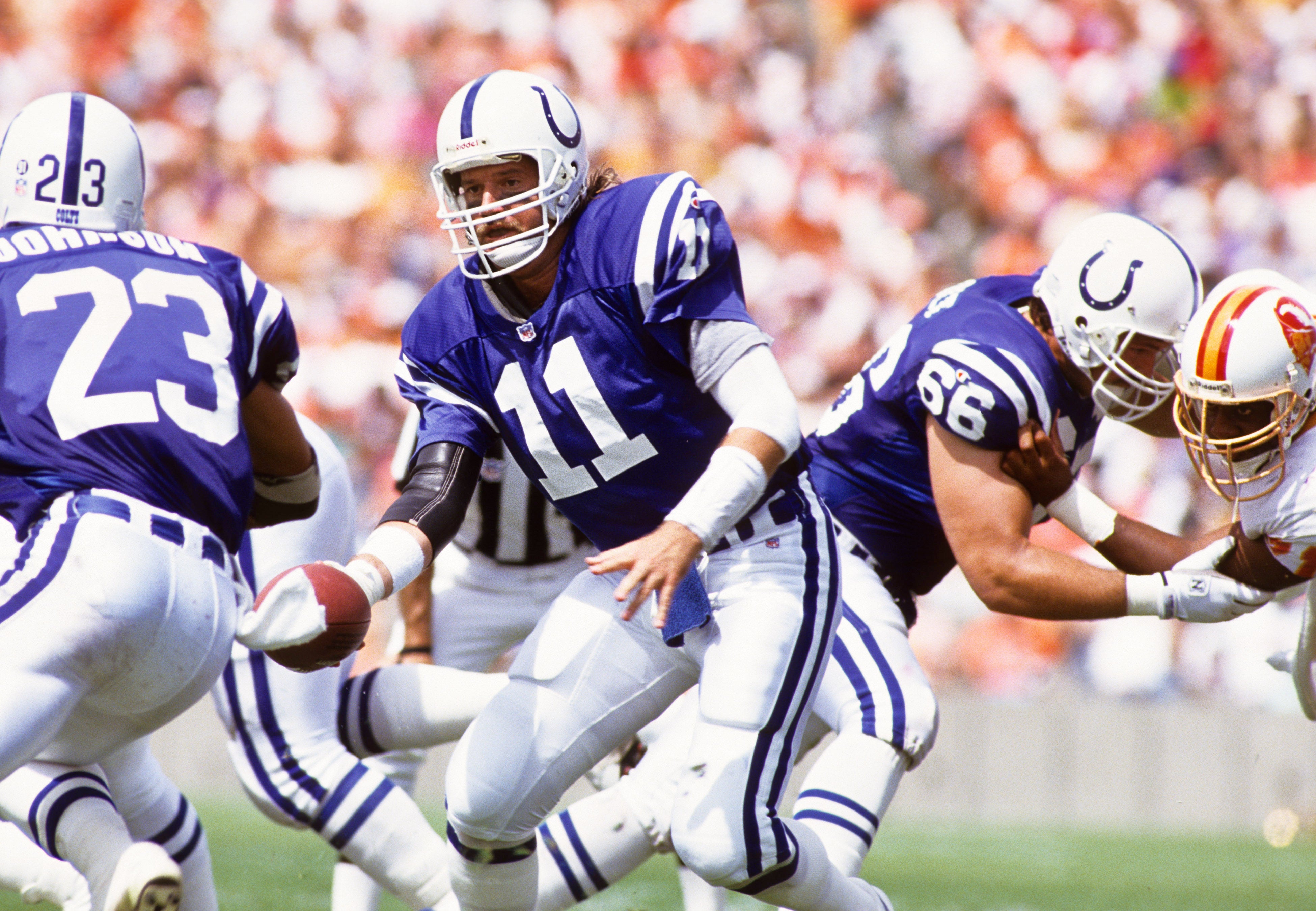 Oct 4, 1992; Tampa, FL, USA; FILE PHOTO; Indianapolis Colts quarterback Jeff George (11) hands the ball off to Anthony Johnson (23) behind the blocking of Ron Solt (66) against the Tampa Bay Buccaneers at Tampa Stadium.