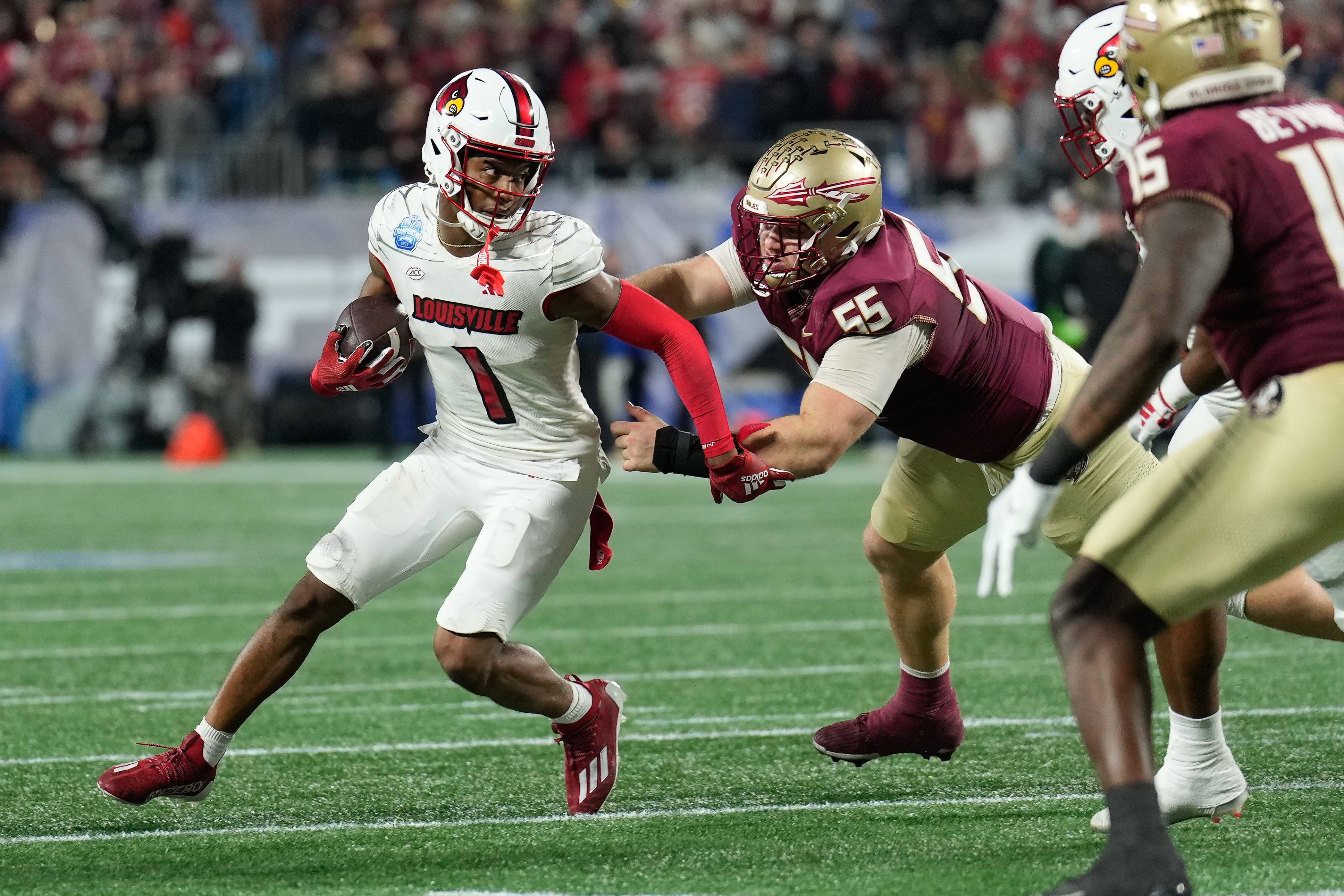 Dec 2, 2023; Charlotte, NC, USA; Louisville Cardinals wide receiver Jamari Thrash (1) runs after a catch as Florida State Seminoles defensive lineman Braden Fiske (55) defends during the third quarter at Bank of America Stadium. Mandatory Credit: Jim Dedmon-USA TODAY Sports