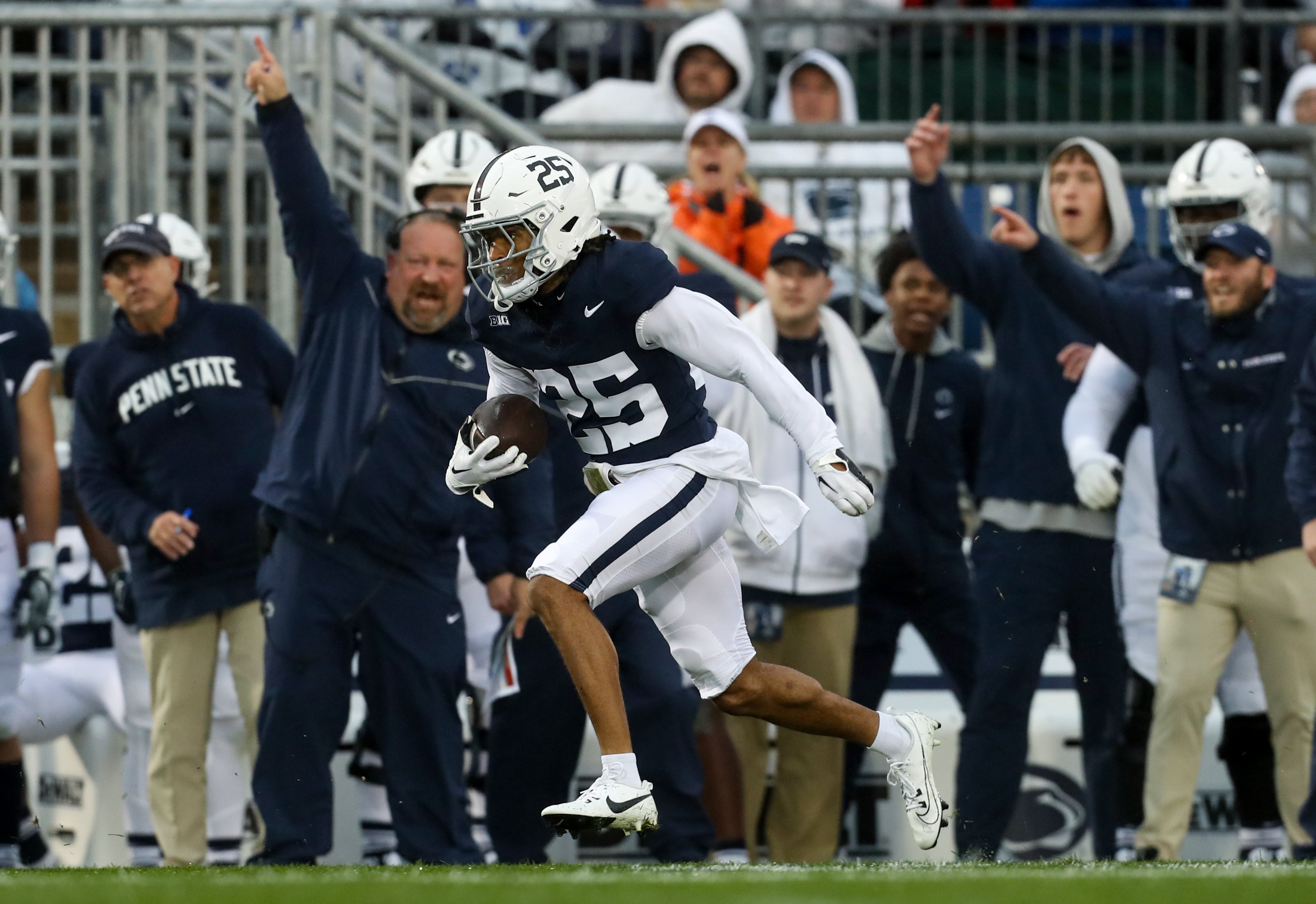 Oct 14, 2023; University Park, Pennsylvania, USA; Penn State Nittany Lions cornerback Daequan Hardy (25) runs the ball on a punt return, resulting in a touchdown during the first quarter against the Massachusetts Minutemen at Beaver Stadium.