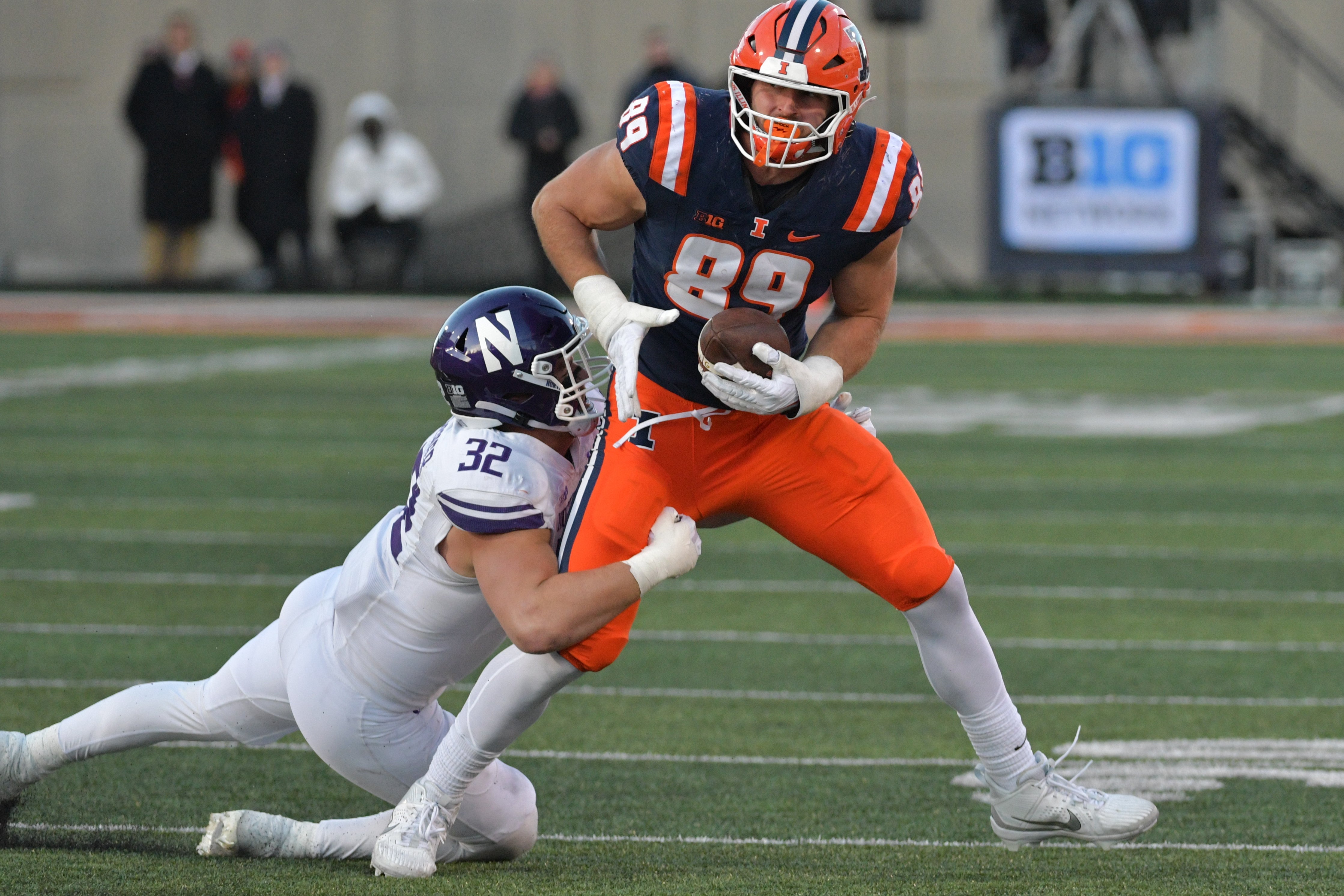 Nov 25, 2023; Champaign, Illinois, USA; Illinois Fighting Illini tight end Tip Reiman (89) is tackled by Northwestern Wildcats linebacker Bryce Gallagher (32) during the first half at Memorial Stadium.