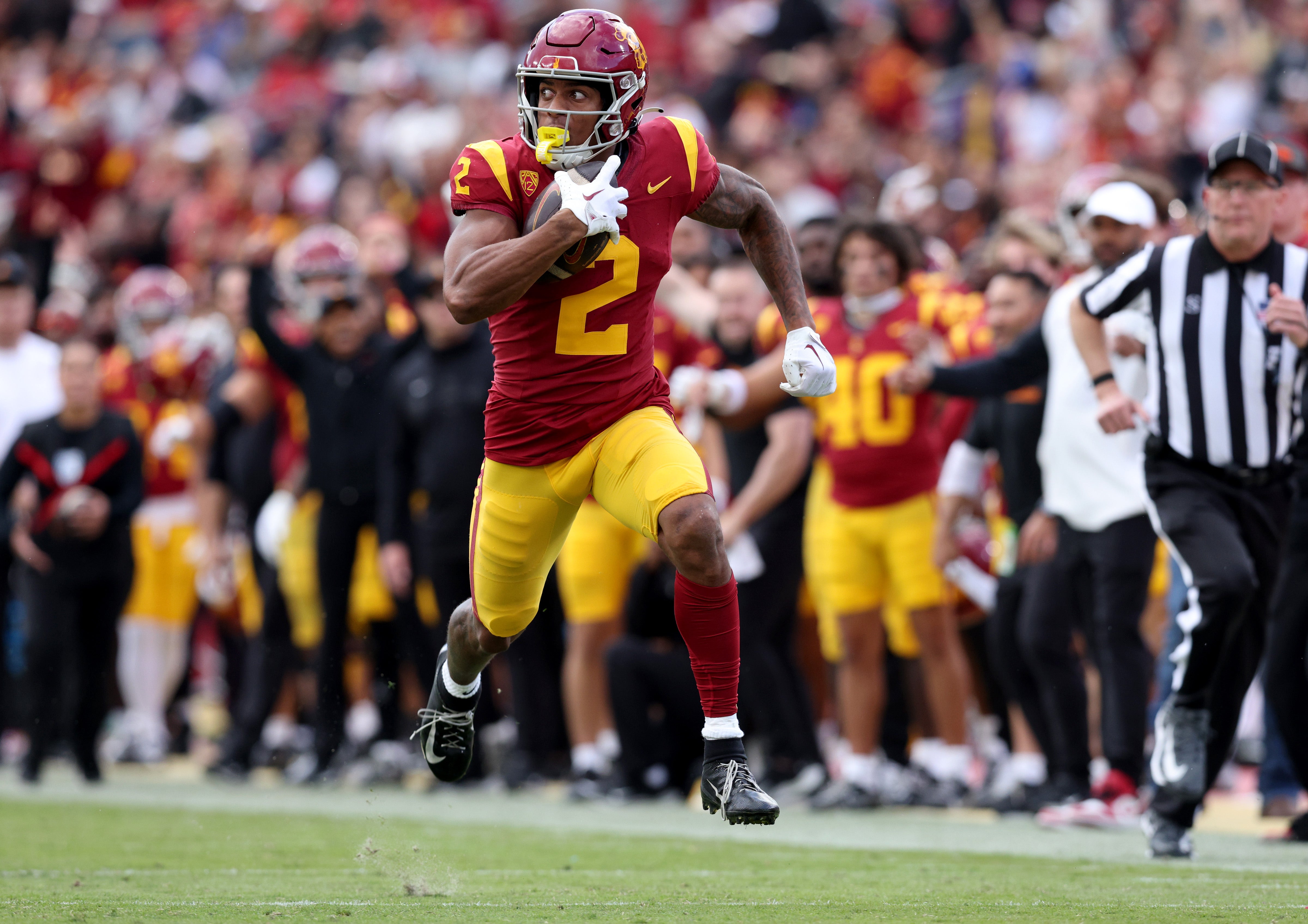 Nov 18, 2023; Los Angeles, California, USA; USC Trojans wide receiver Brenden Rice (2) catches a touchdown during the second quarter against the UCLA Bruins at United Airlines Field at Los Angeles Memorial Coliseum.