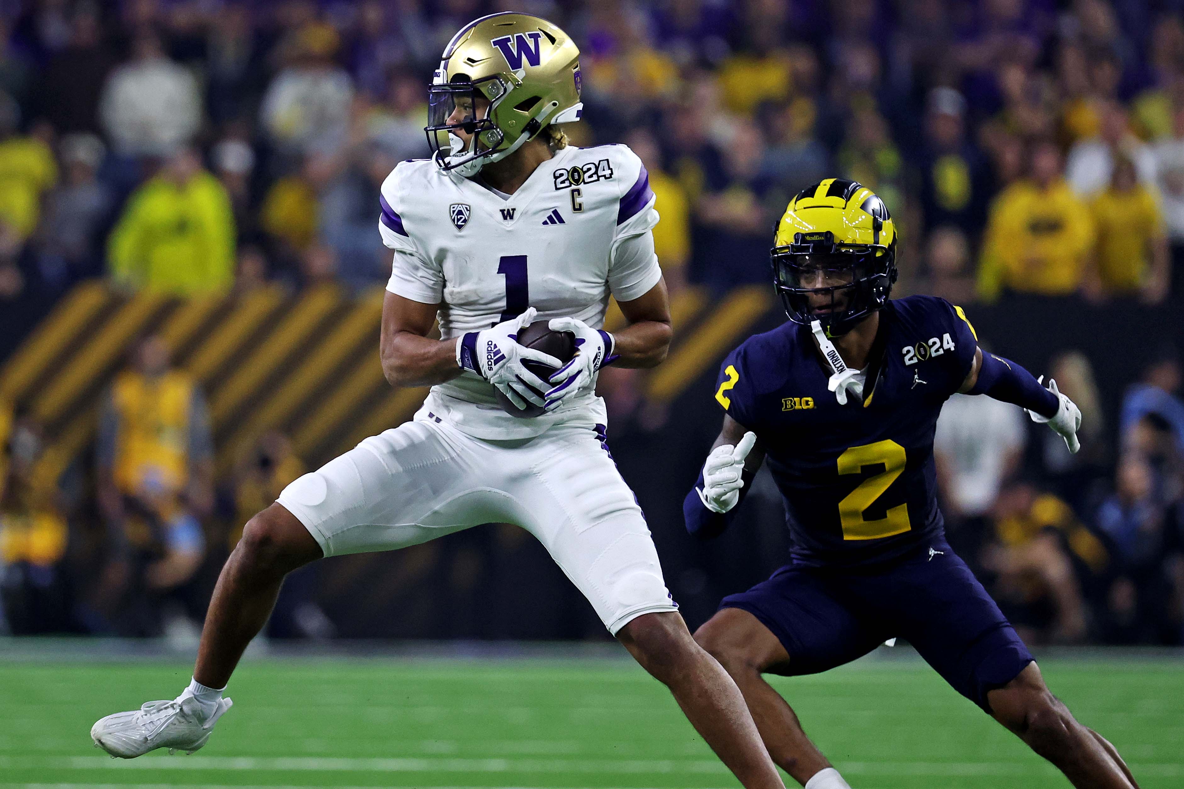 Jan 8, 2024; Houston, TX, USA; Washington Huskies wide receiver Rome Odunze (1) catches a pass against Michigan Wolverines defensive back Will Johnson (2) during the second quarter in the 2024 College Football Playoff national championship game at NRG Stadium. Mandatory Credit: Troy Taormina-USA TODAY Sports