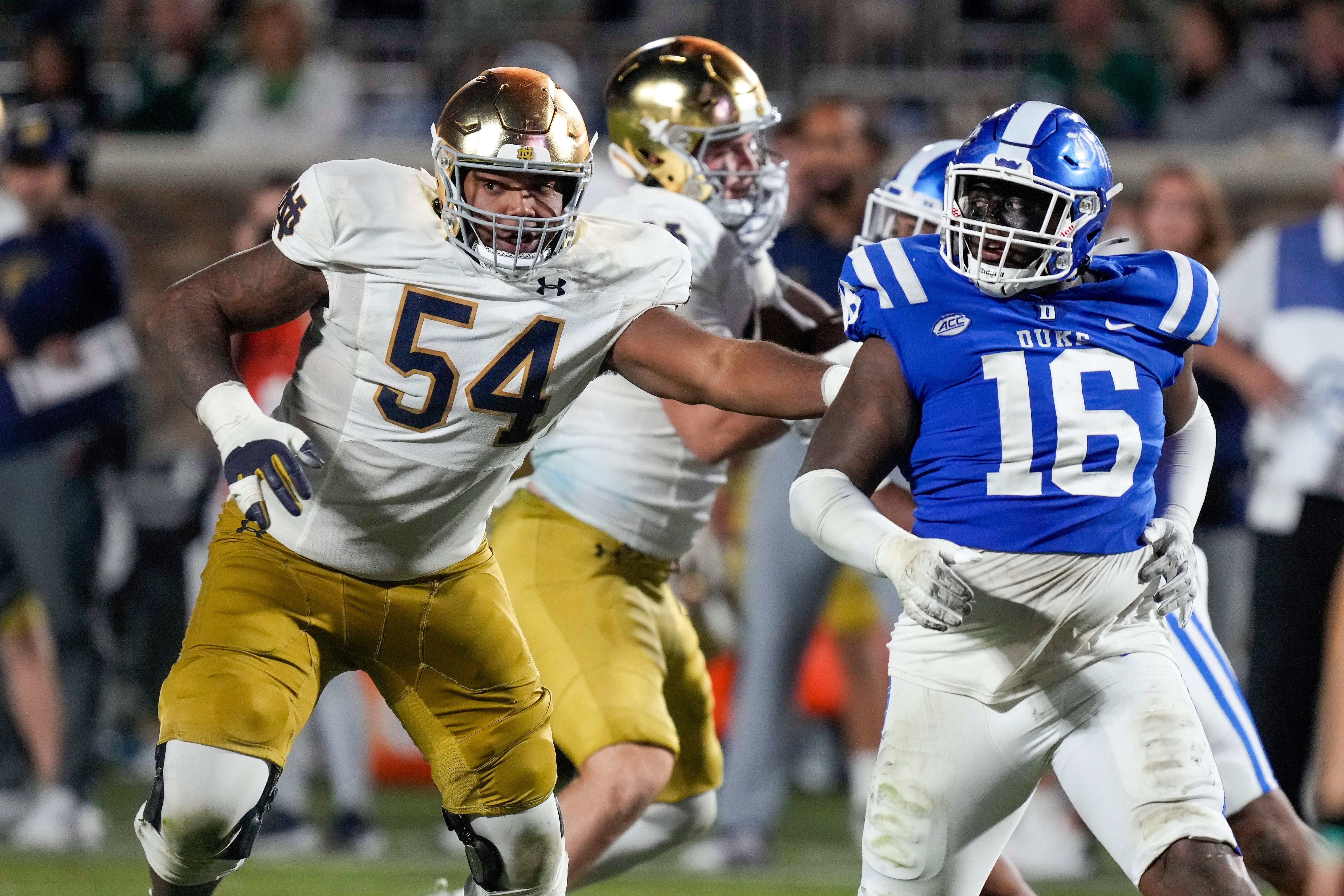 Notre Dame Fighting Irish offensive lineman Blake Fisher (54) blocks Duke Blue Devils defensive tackle Aeneas Peebles (16) during the second half at Wallace Wade Stadium.