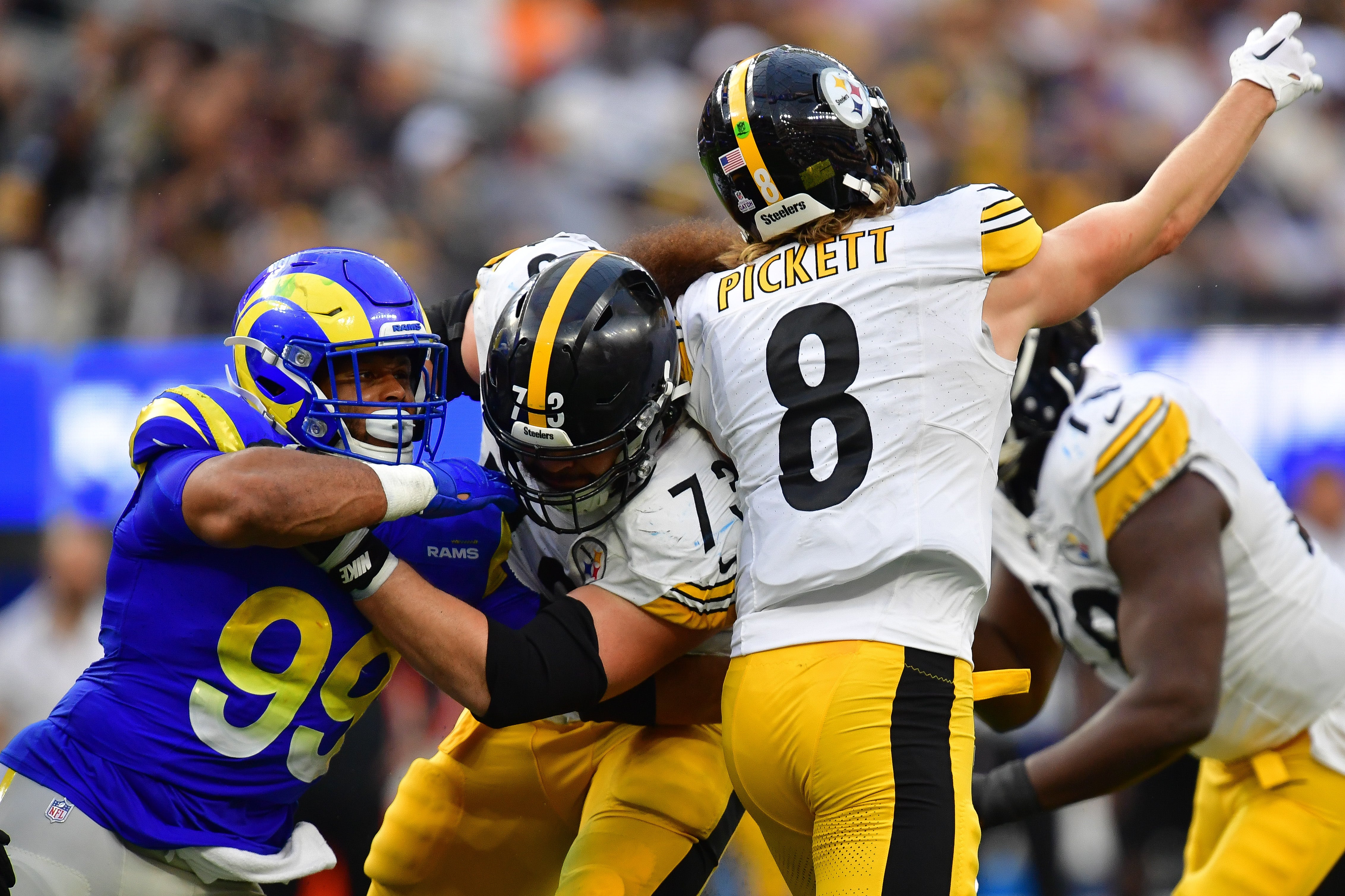 Oct 22, 2023; Inglewood, California, USA; Pittsburgh Steelers quarterback Kenny Pickett (8) throws as guard Isaac Seumalo (73) provides coverage against Los Angeles Rams defensive tackle Aaron Donald (99) during the second half at SoFi Stadium. Mandatory Credit: Gary A. Vasquez-USA TODAY Sports  