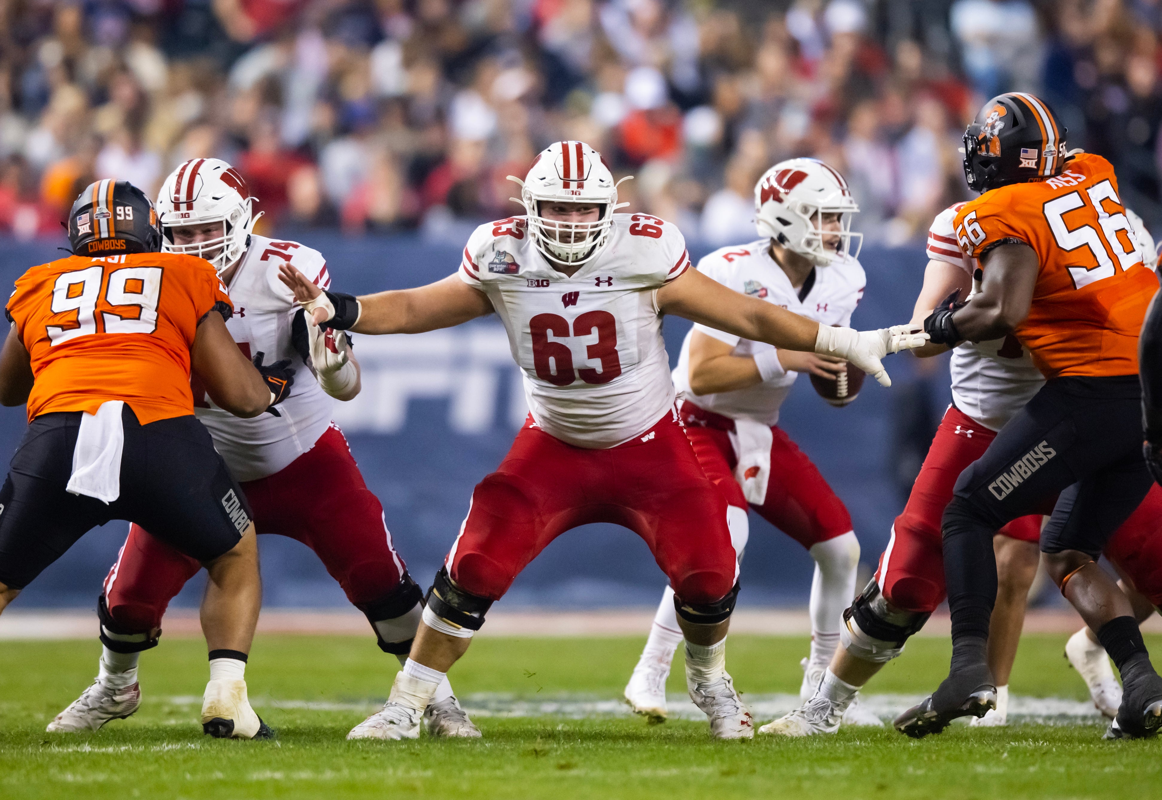 Dec 27, 2022; Phoenix, Arizona, USA; Wisconsin Badgers offensive lineman Tanor Bortolini (63) against the Oklahoma State Cowboys during the 2022 Guaranteed Rate Bowl at Chase Field.