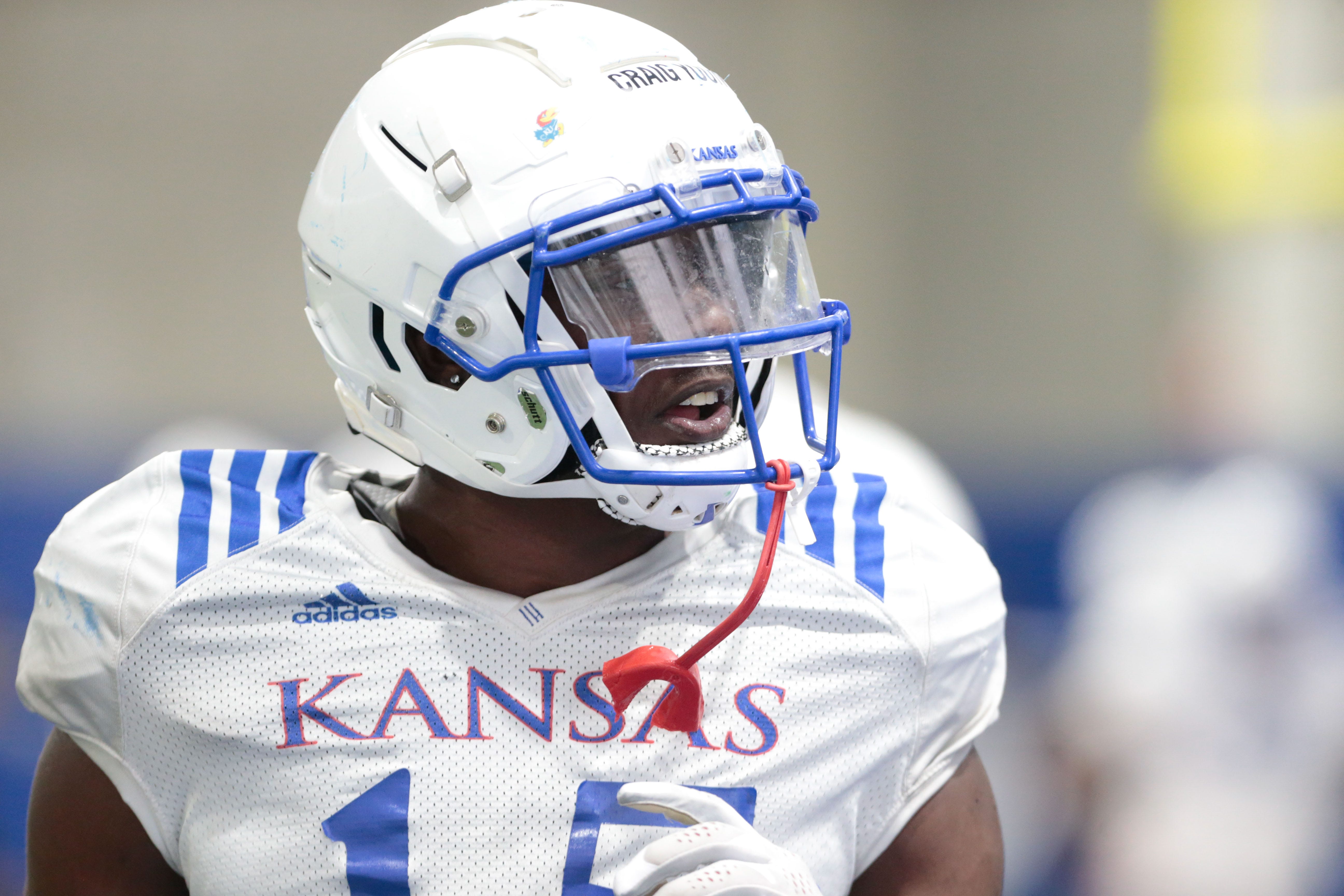 Kansas redshirt senior linebacker Craig Young (15) moves to the next drill during Tuesday's practice at the Indoor Football Facility.