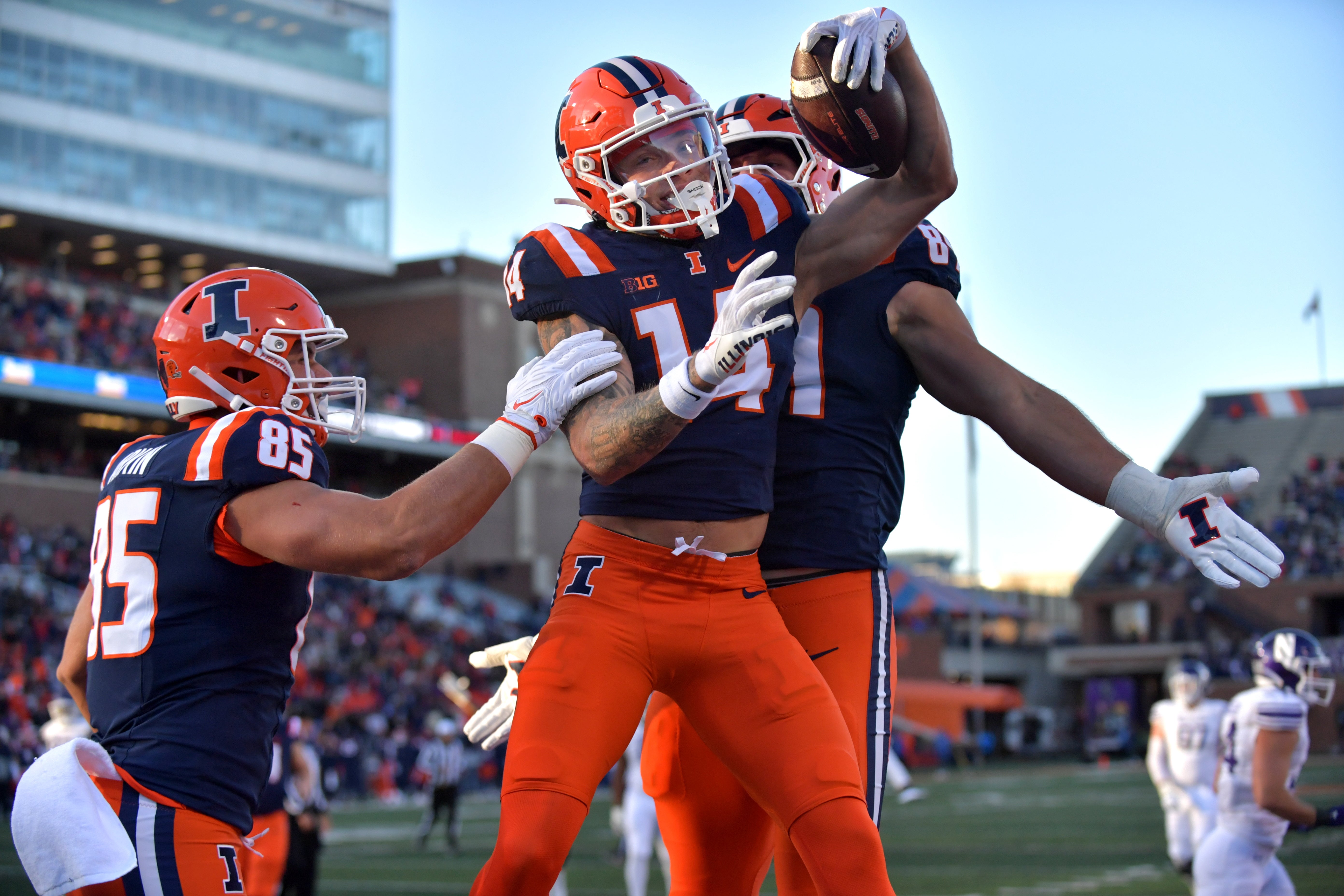 Illinois Fighting Illini wide receiver Casey Washington (14) celebrates a touchdown with teammates during the first half against the Northwestern Wildcats at Memorial Stadium.