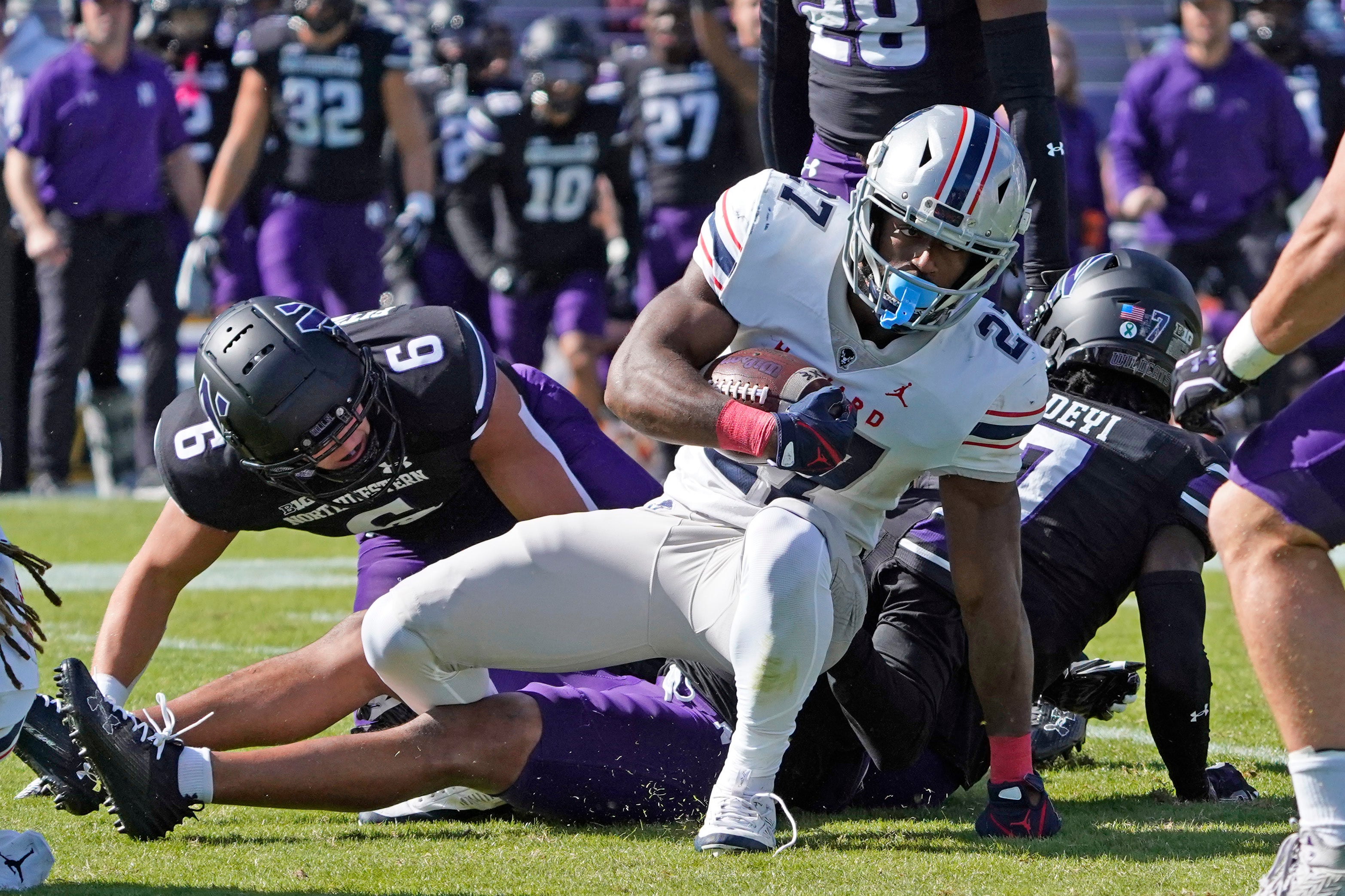 Oct 7, 2023; Evanston, Illinois, USA; Northwestern Wildcats defensive back Ore Adeyi (7) tackles Howard Bison running back Ian Wheeler (27) during the first half at Ryan Field.