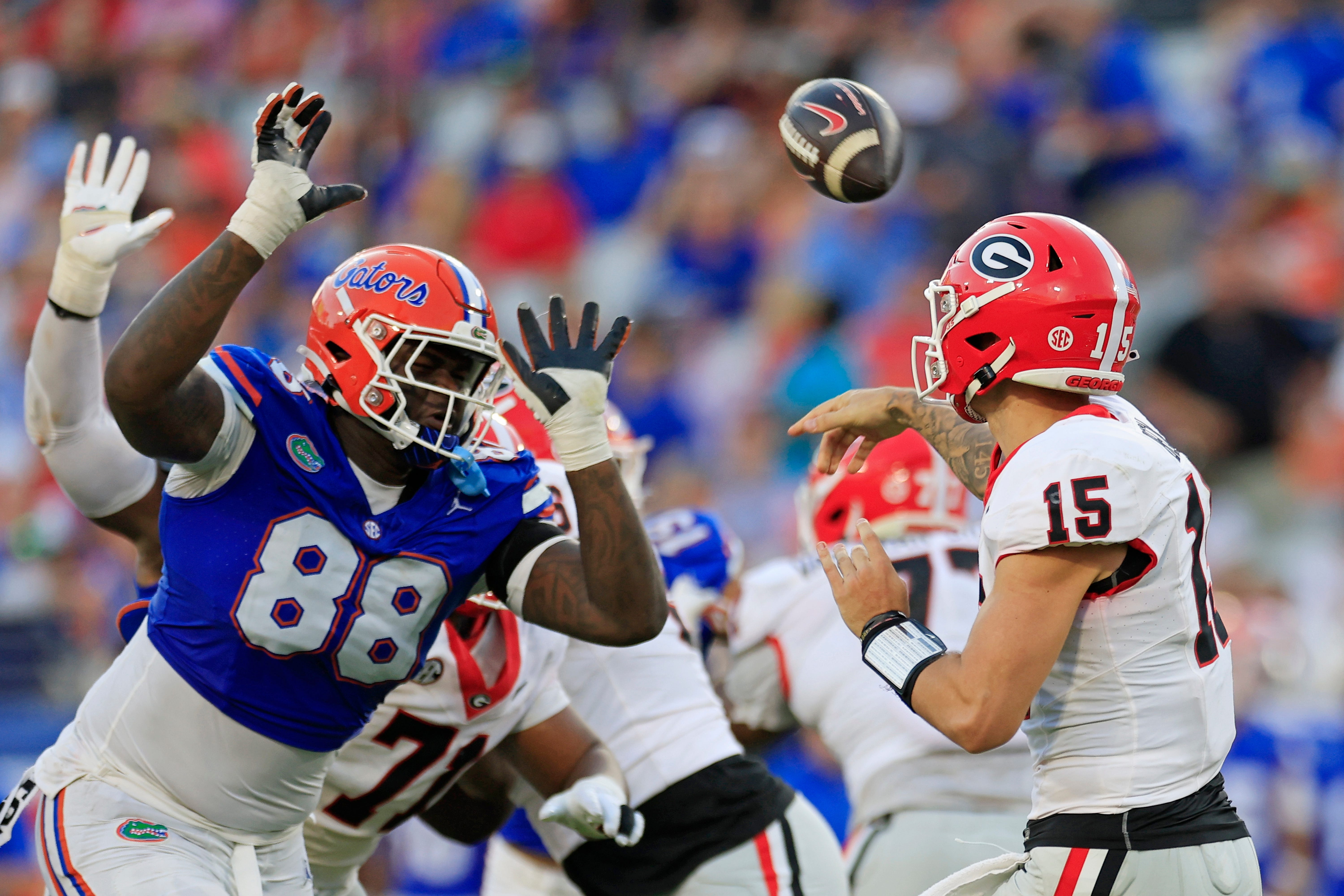 Georgia Bulldogs quarterback Carson Beck (15) is pressured by Florida Gators defensive lineman Caleb Banks (88) during the third quarter of an NCAA football game Saturday, Oct. 28, 2023 at EverBank Stadium in Jacksonville, Fla. Georgia defeated Florida 43-20
