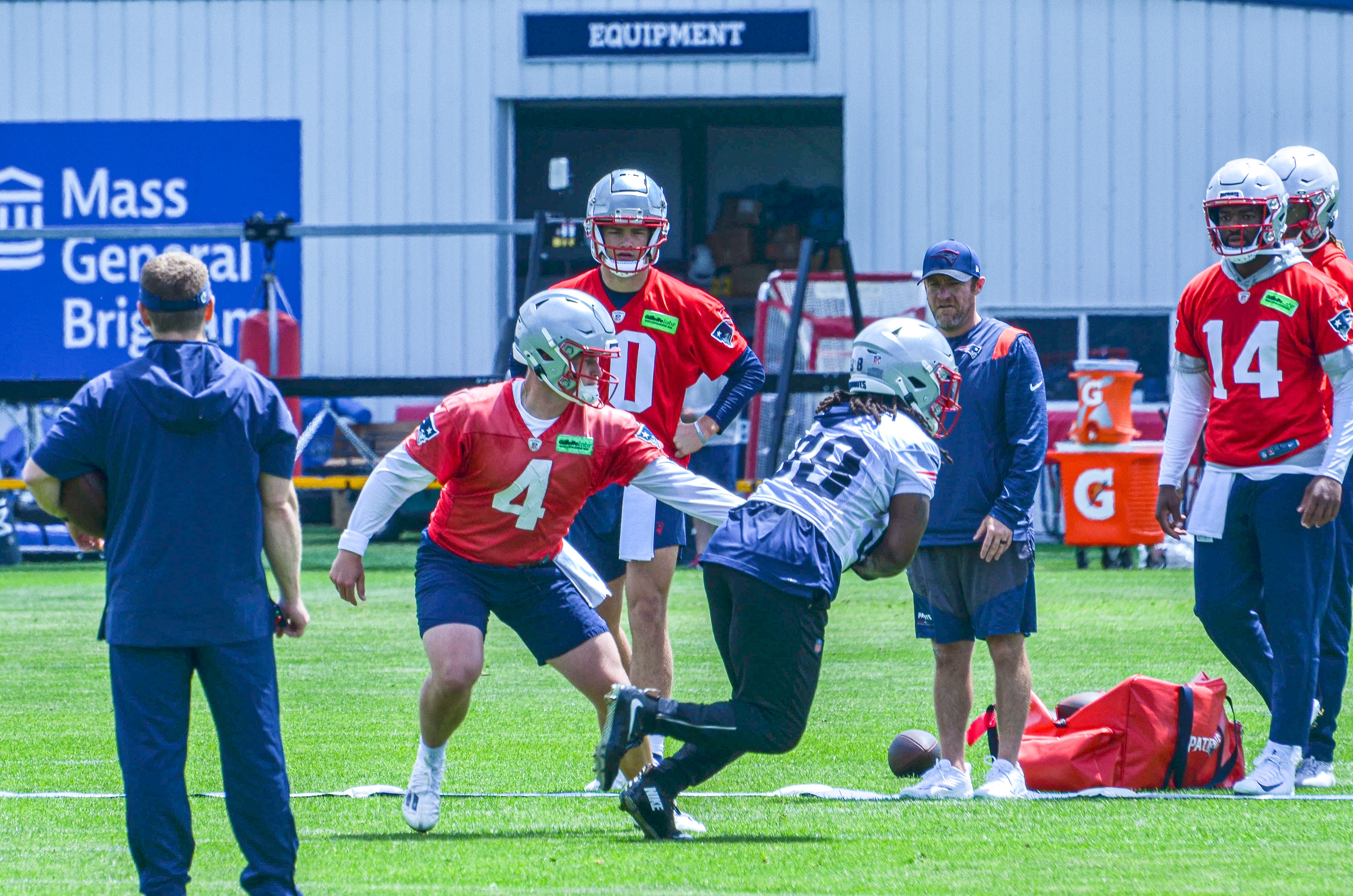 Monday, May 20 - Patriots QB Bailey Zappe hands the ball off to RB Rhamondre Stevenson at OTAs