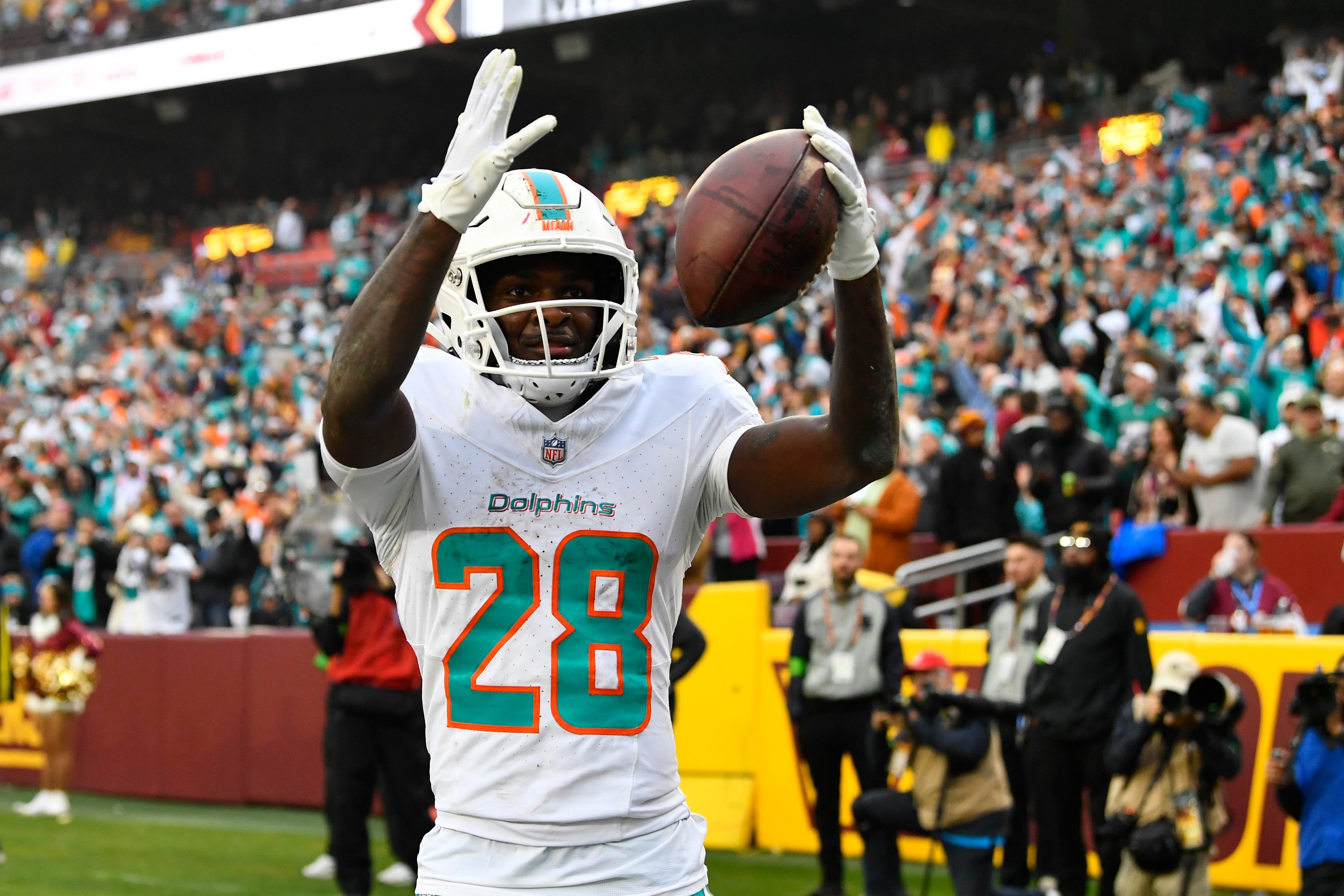 Dec 3, 2023; Landover, Maryland, USA; Miami Dolphins running back De'Von Achane (28) celebrates after scoring a touchdown against the Washington Commanders during the second half at FedExField.
