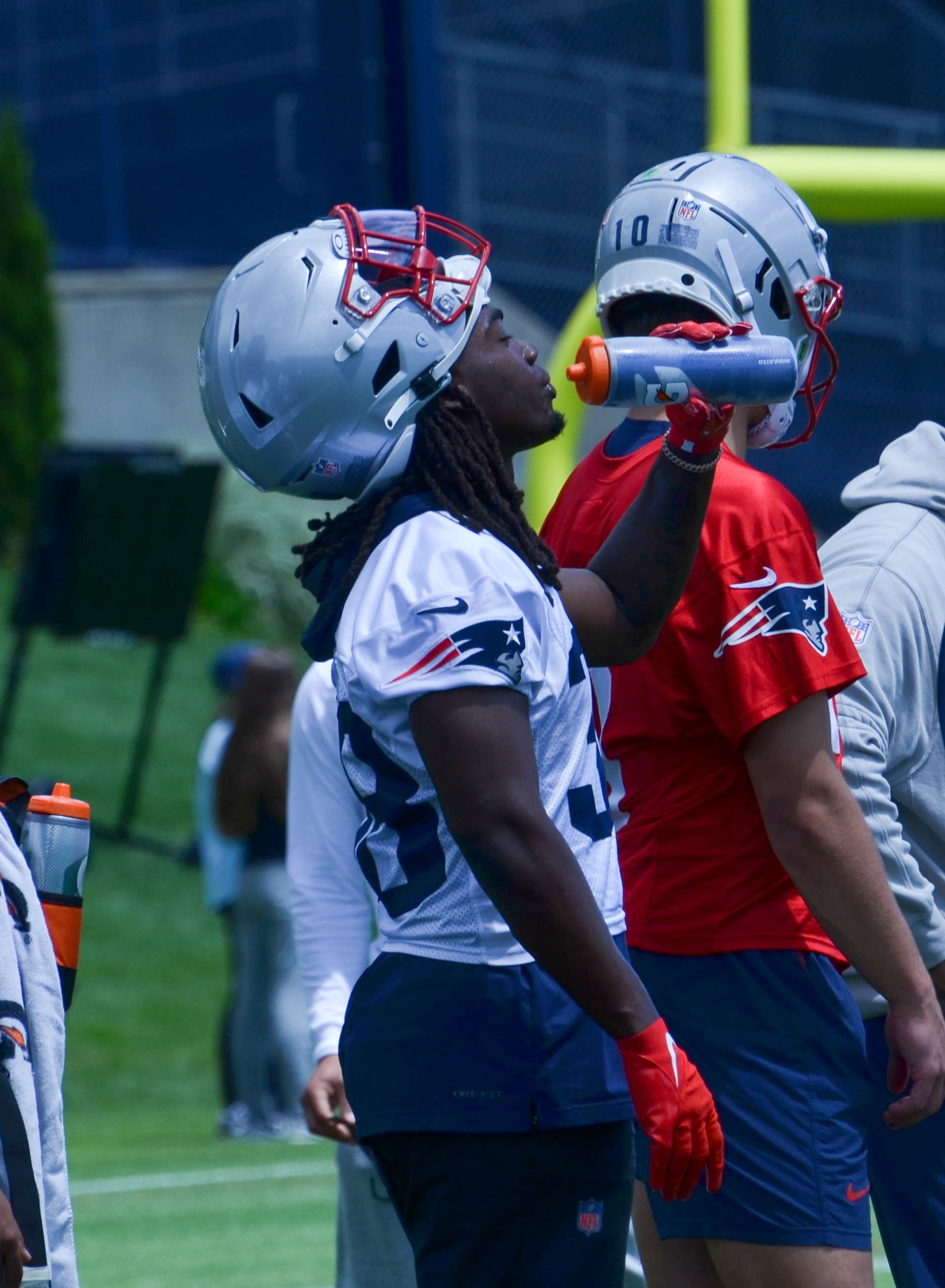 Patriots RB Rhamondre Stevenson drinks some water in between drills at OTAs - May 29, 2024 