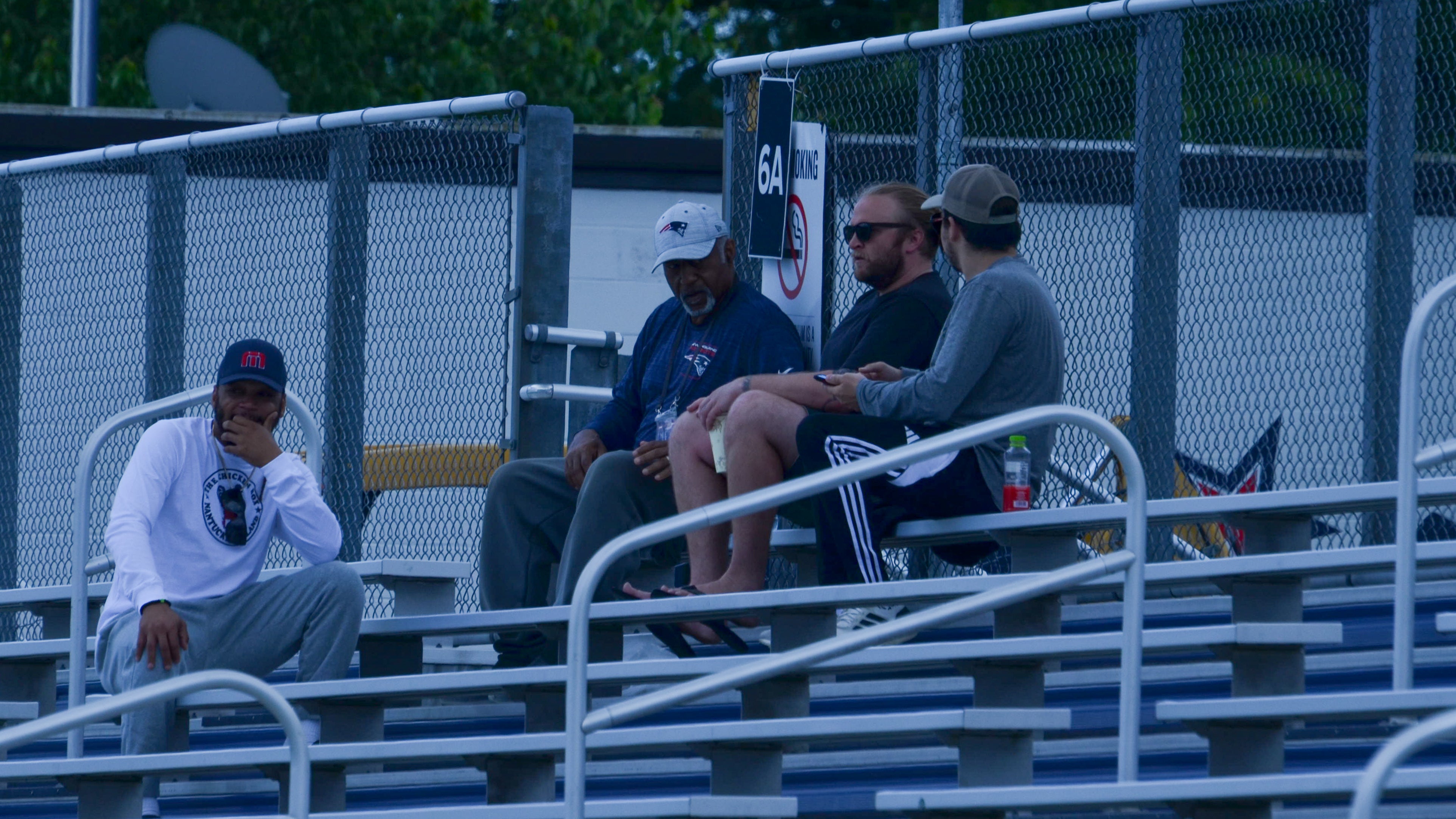 Former Patriots coaches Ivan Fears and Steve Belichick along with former player Patrick Chung watches OTAs from the bleachers at Gillette Stadium - May 29, 2024