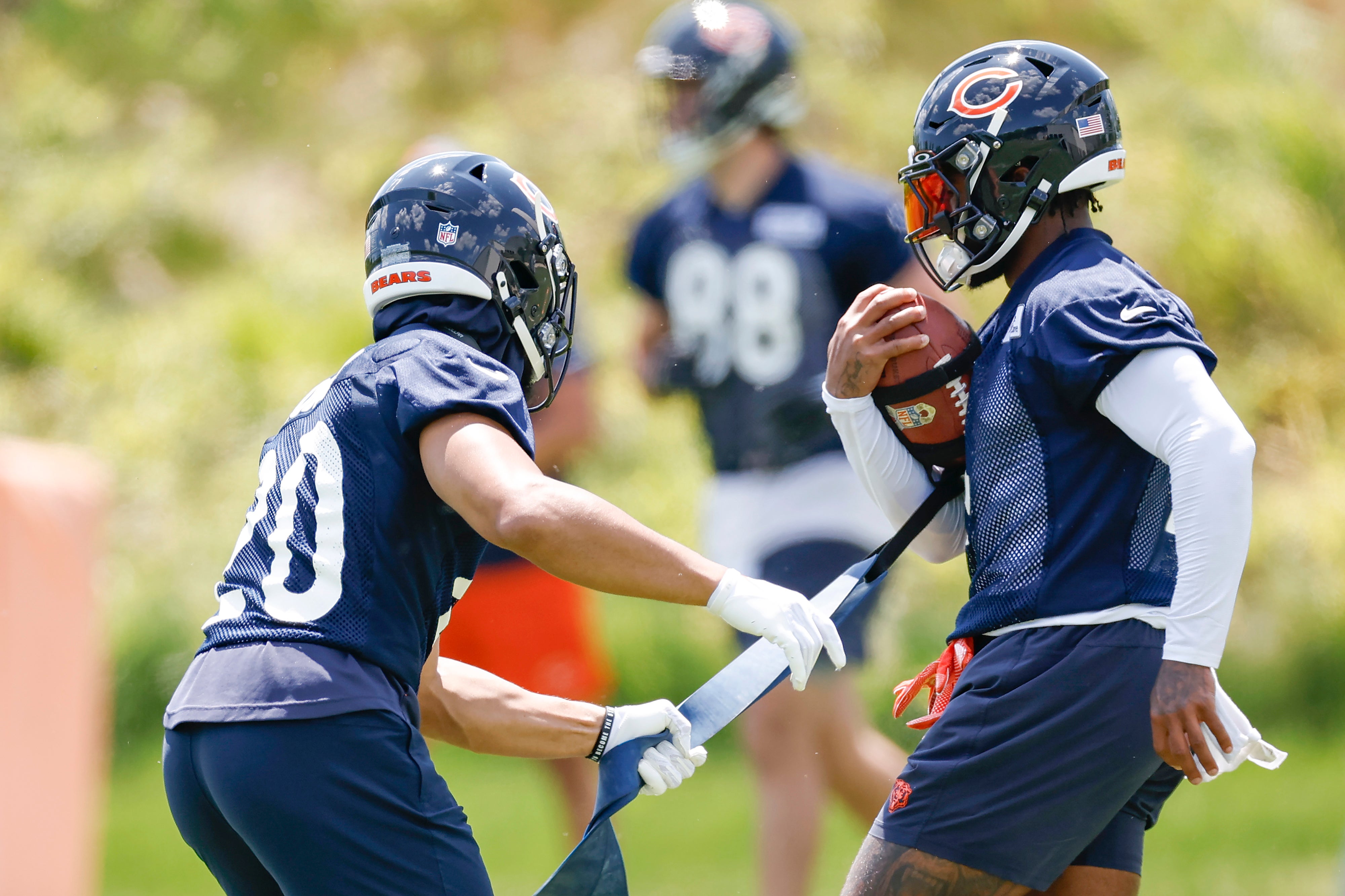 May 23, 2024; Lake Forest, IL, USA; Chicago Bears running backs Travis Homer (L) and D'Andre Swift (R) warm up during organized team activities at Halas Hall.