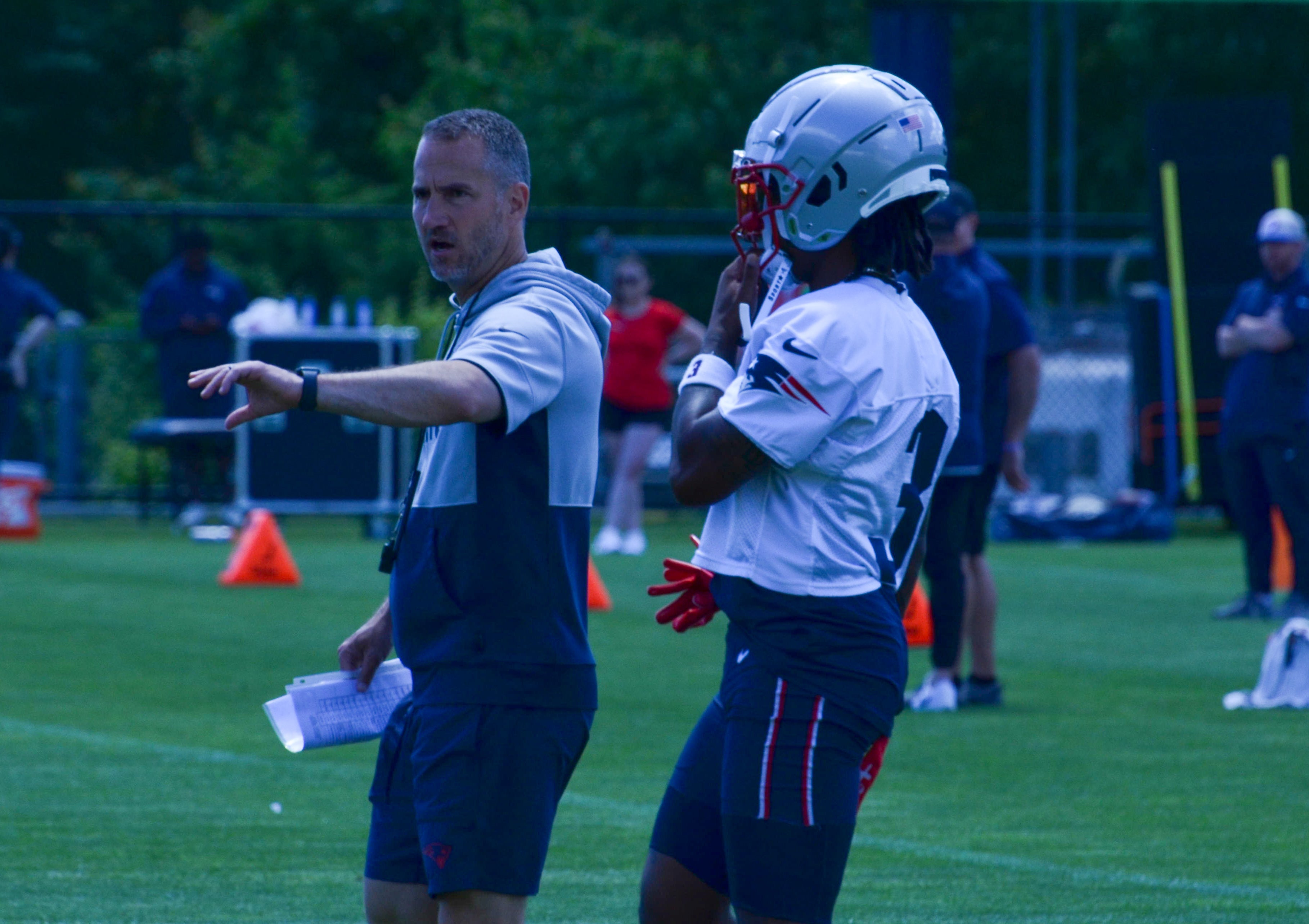 Patriots WR DeMario Douglas gets coached during the first day of Mandatory Minicamp at Gillette Stadium - June 10, 2024