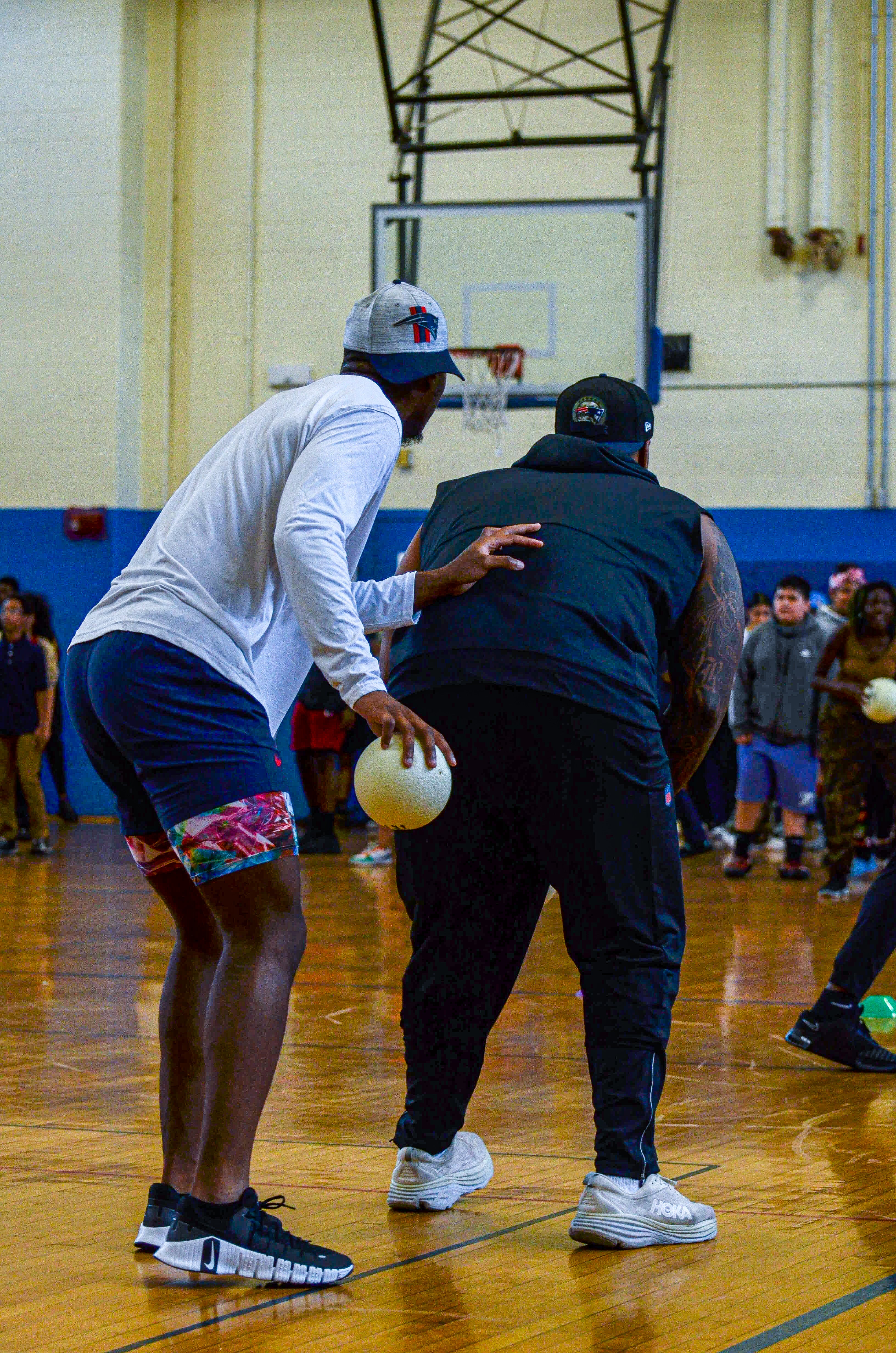 Cornerback Isaiah Bolden uses Guard Nick Leverett as a shield while the players plays dodgeball against students at the New England Patriots community event at the Perkins Community Center/Lee School - June 11, 2024
