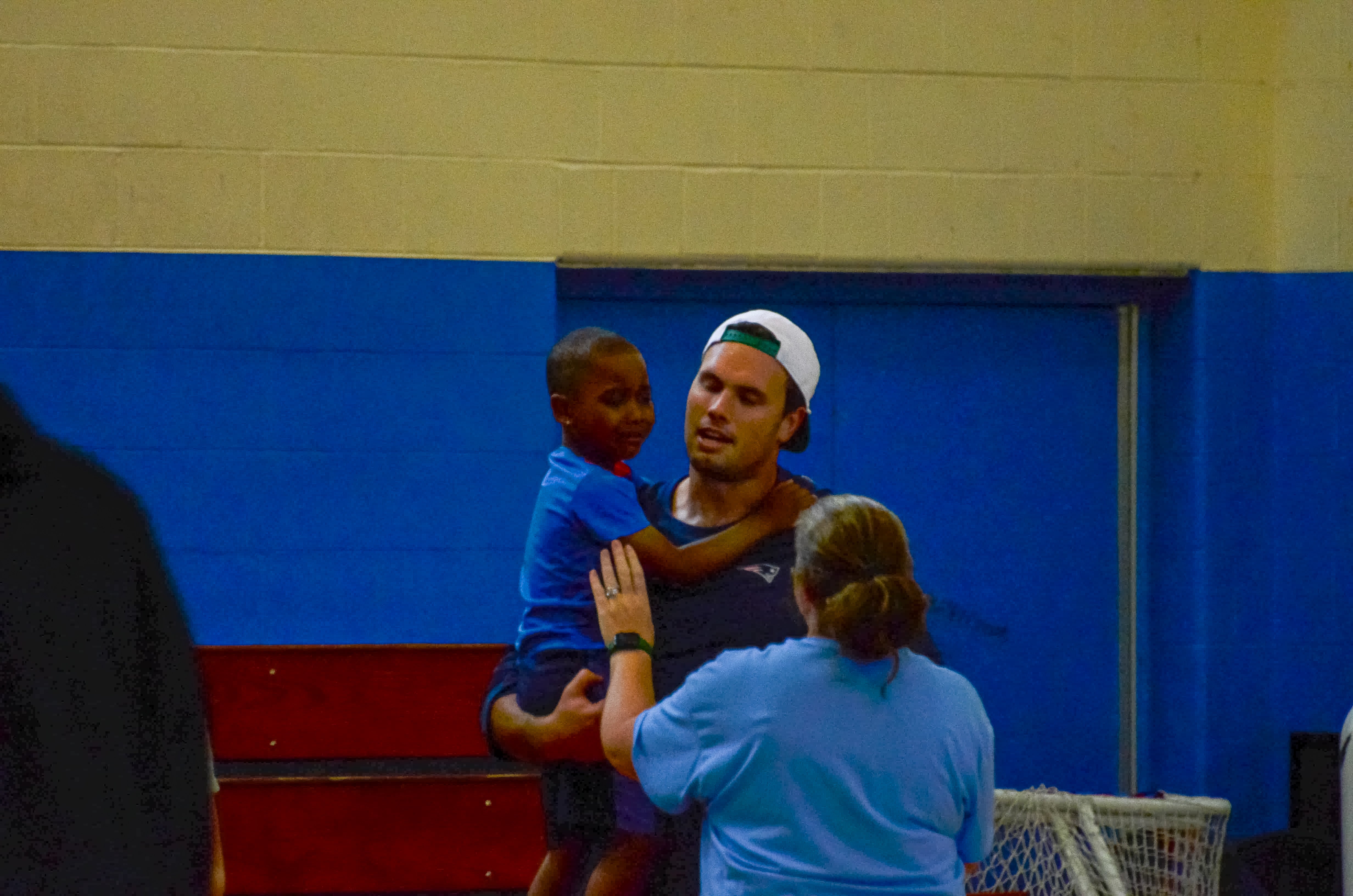 Tight end Hunter Henry Drake comforts a student at the New England Patriots community event at the Perkins Community Center/Lee School - June 11, 2024