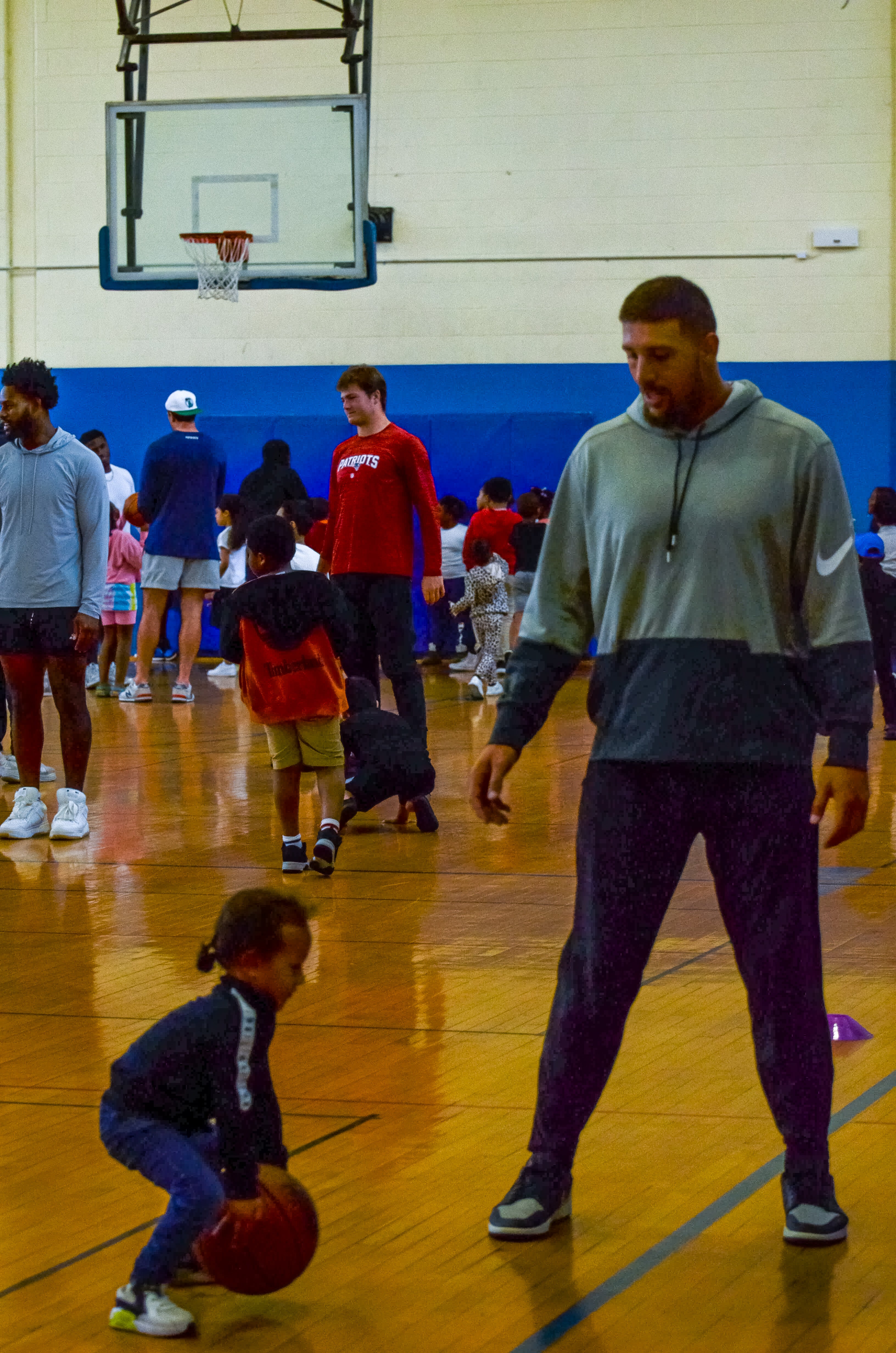 Tight end Austin Hooper helps one of the student play basketball at the New England Patriots community event at the Perkins Community Center/Lee School - June 11, 2024