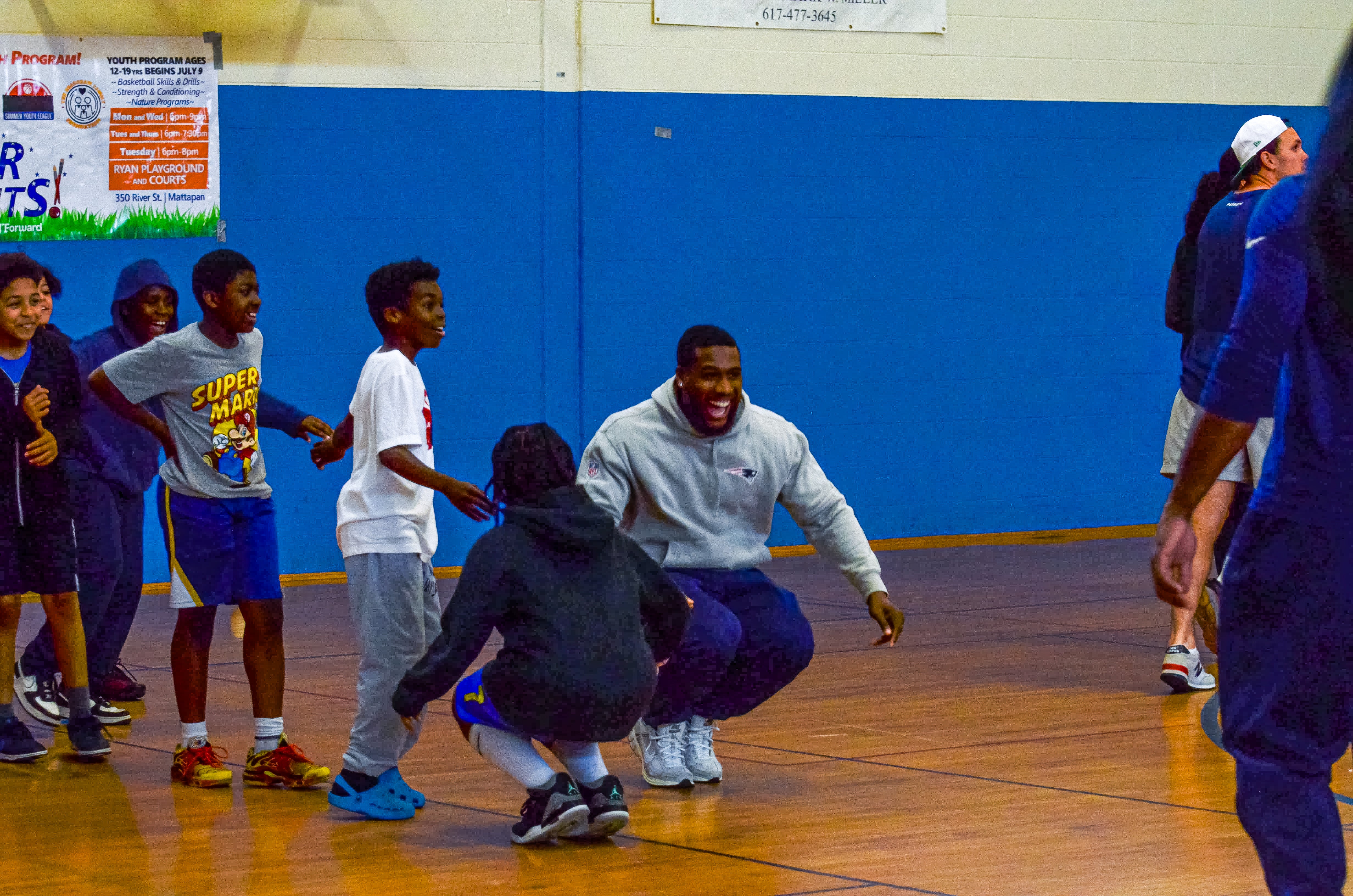 A player dances with the students during the New England Patriots community event at the Perkins Community Center/Lee School - June 11, 2024