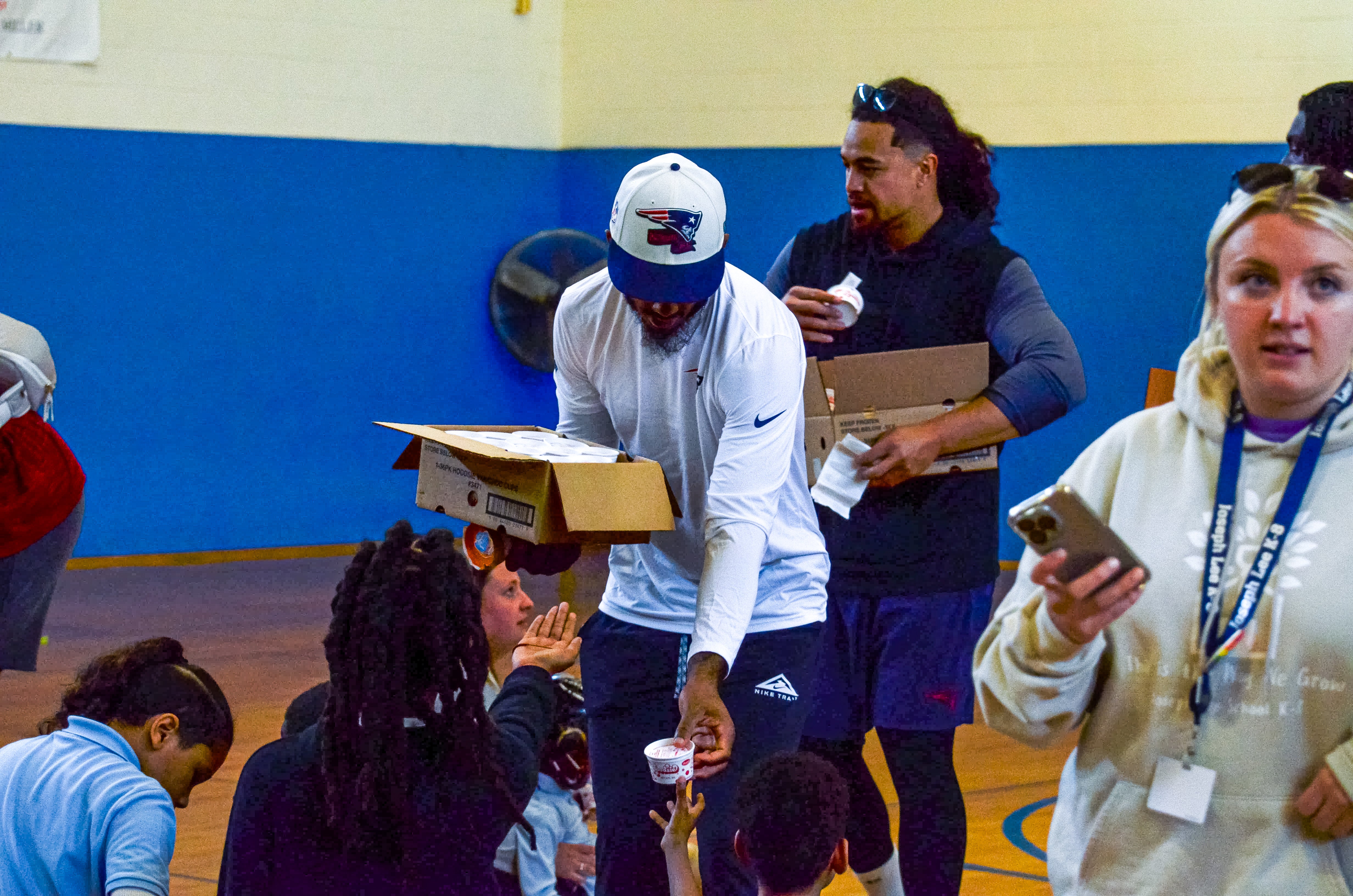 wide receiver Ja'Lynn Polk and linebacker Sione Takitaki handout ice cream during the New England Patriots community event at the Perkins Community Center/Lee School - June 11, 2024