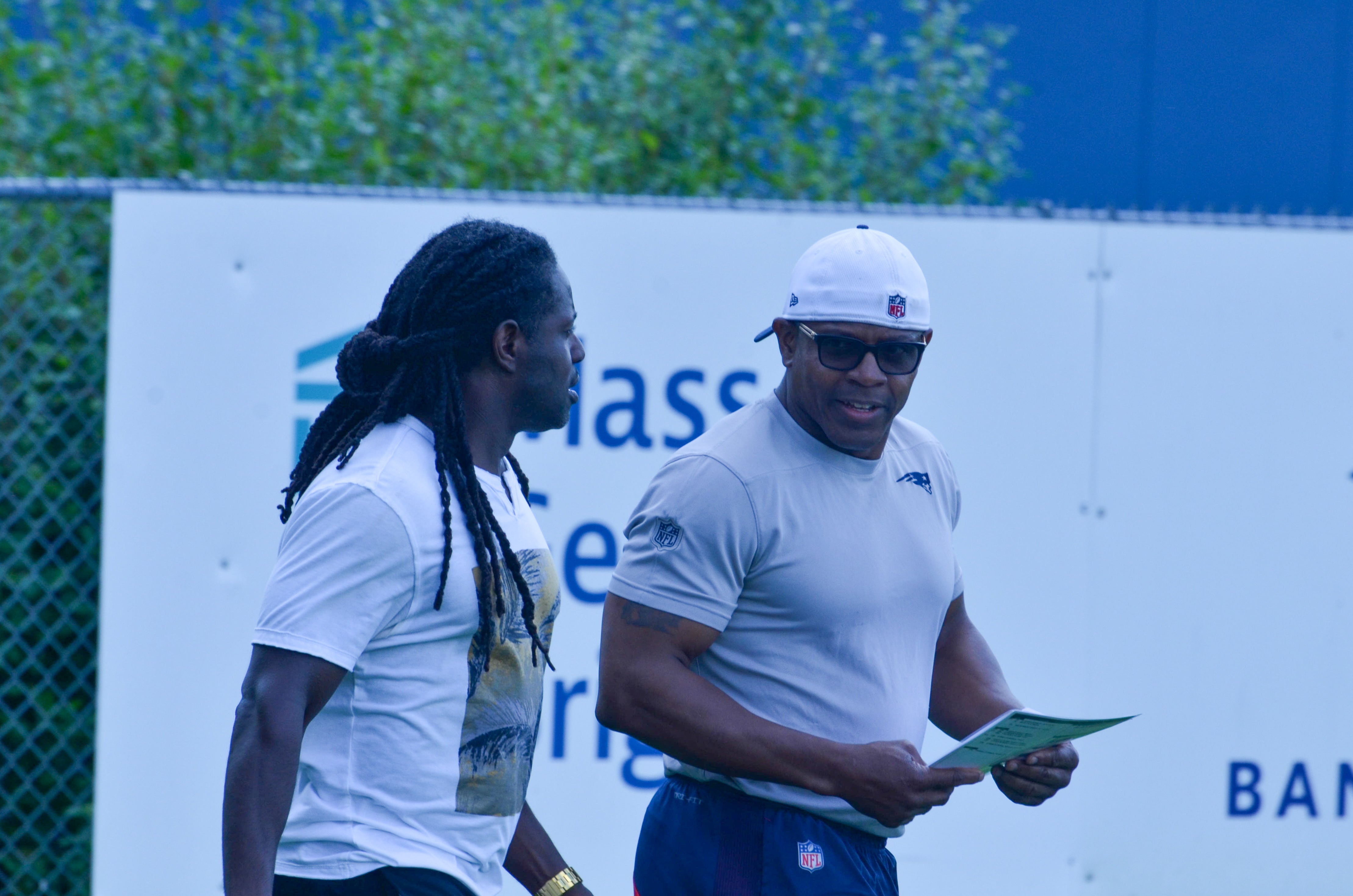 Patriots legend Deion Branch walks out with Troy Brown prior to the team's final day of mandatory minicamp - June 12, 2024