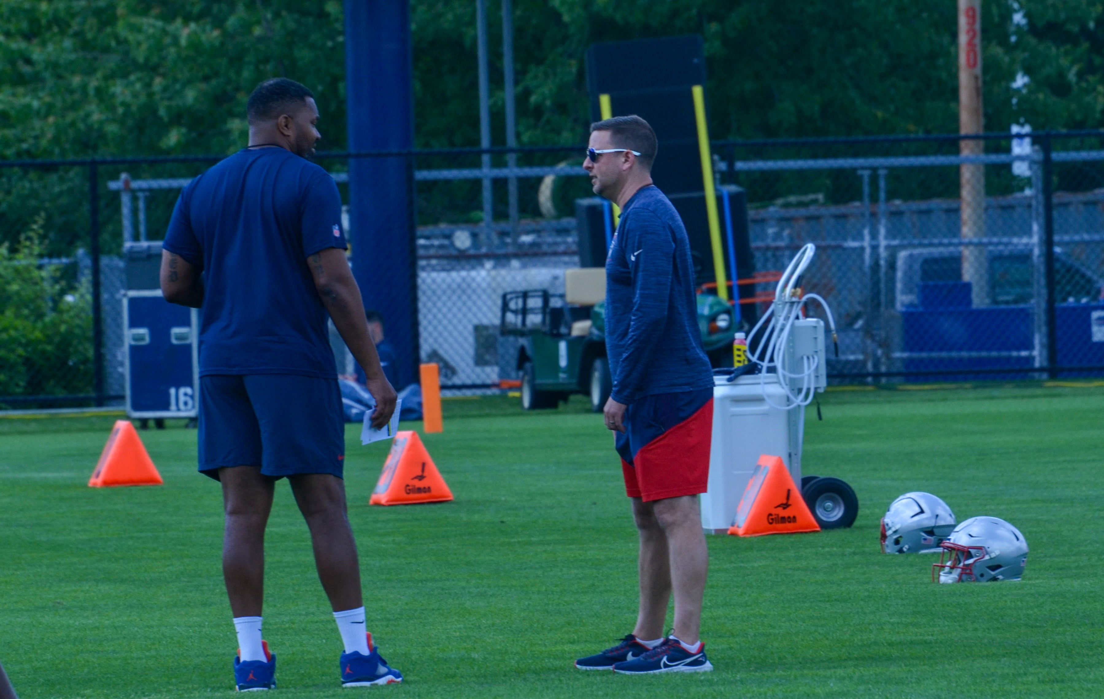 Patriots head coach Jerod Mayo speaks with Eliot Wolf at the team's final day of mandatory minicamp - June 12, 2024