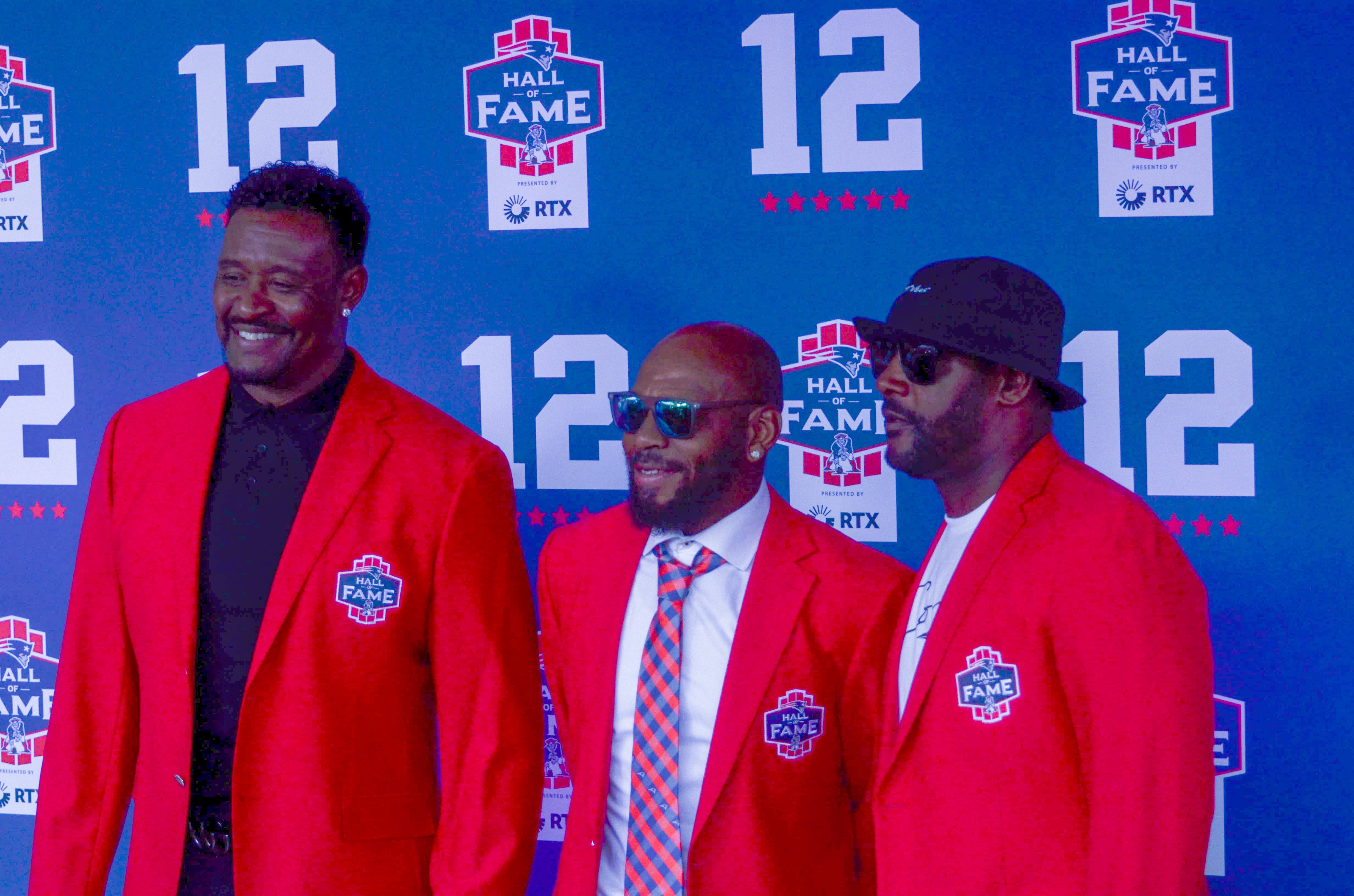 Patriots Hall of Famers Willie McGinest (left), Kevin Faulk (center) and Ty Law (right). Former teammates, coaches, friends, family, and 60,000 fans were at Gillette Stadium for the induction of Tom Brady into the New England Patriots Hall of Fame Wednesday, June 12 in Foxborough, Mass.