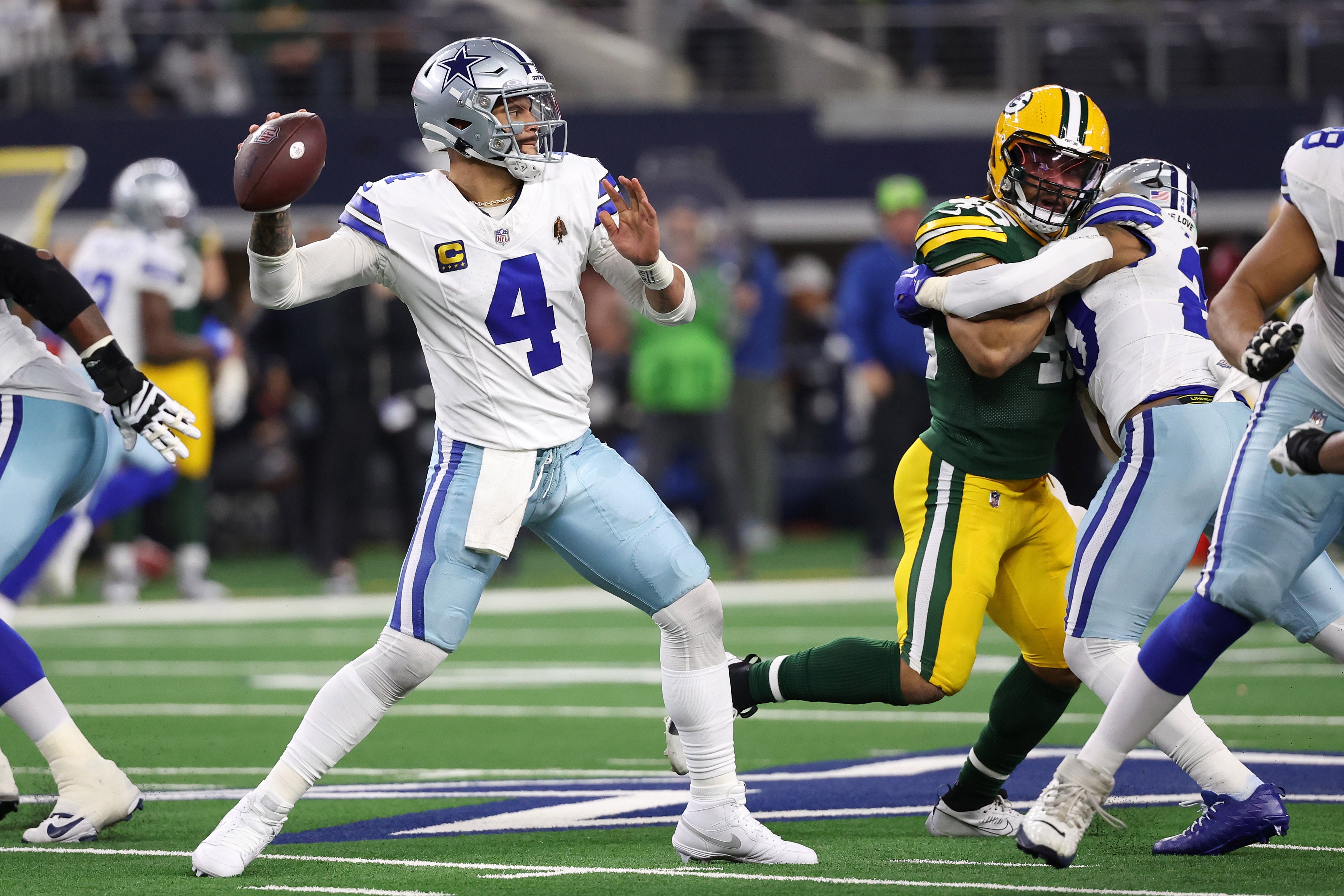 Dallas Cowboys quarterback Dak Prescott (4) drops back to pass against the Green Bay Packers during the second half for the 2024 NFC wild card game at AT&T Stadium.
