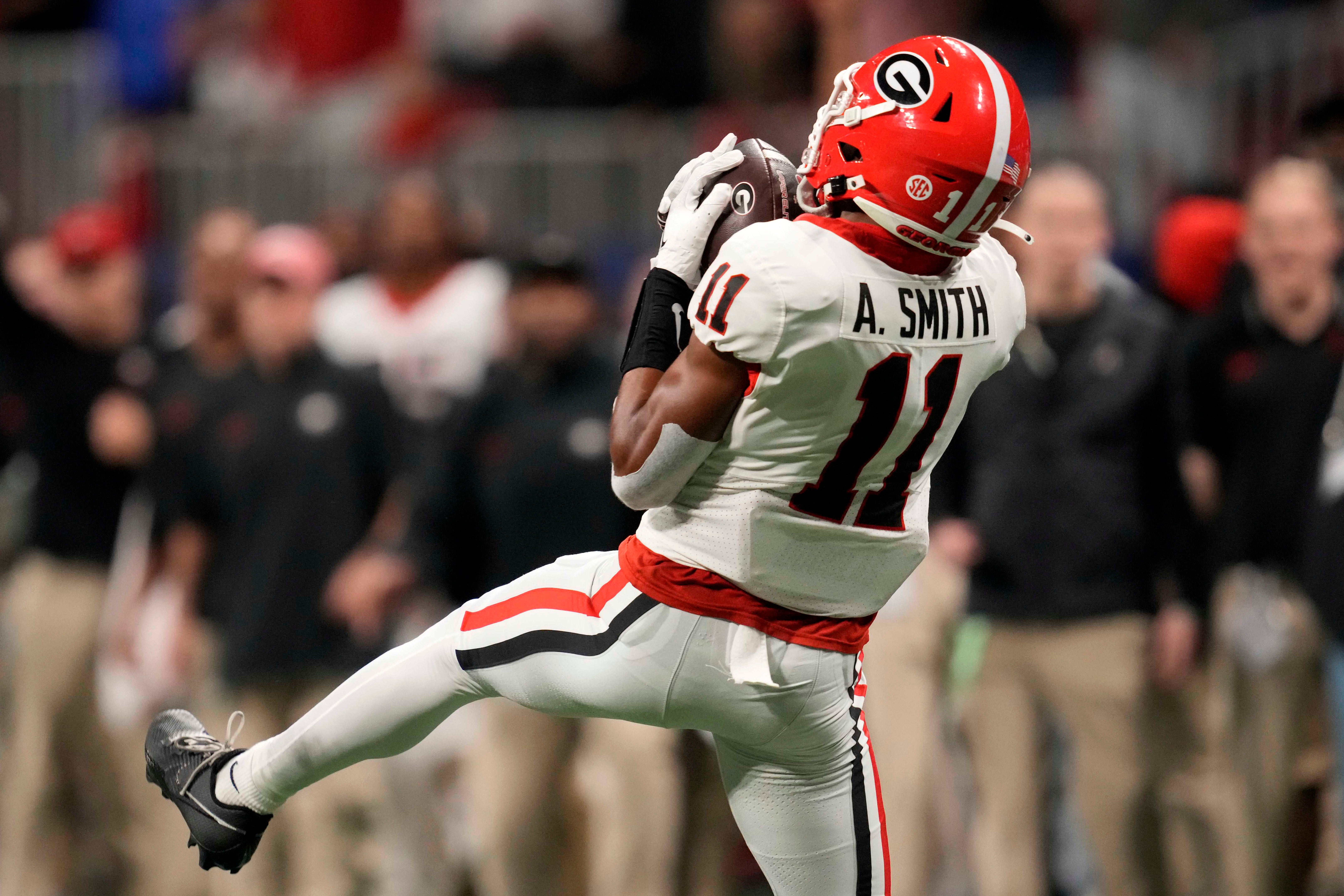 Georgia Bulldogs wide receiver Arian Smith (11) makes a catch against the Alabama Crimson Tide during the second half in the SEC Championship game at Mercedes-Benz Stadium.