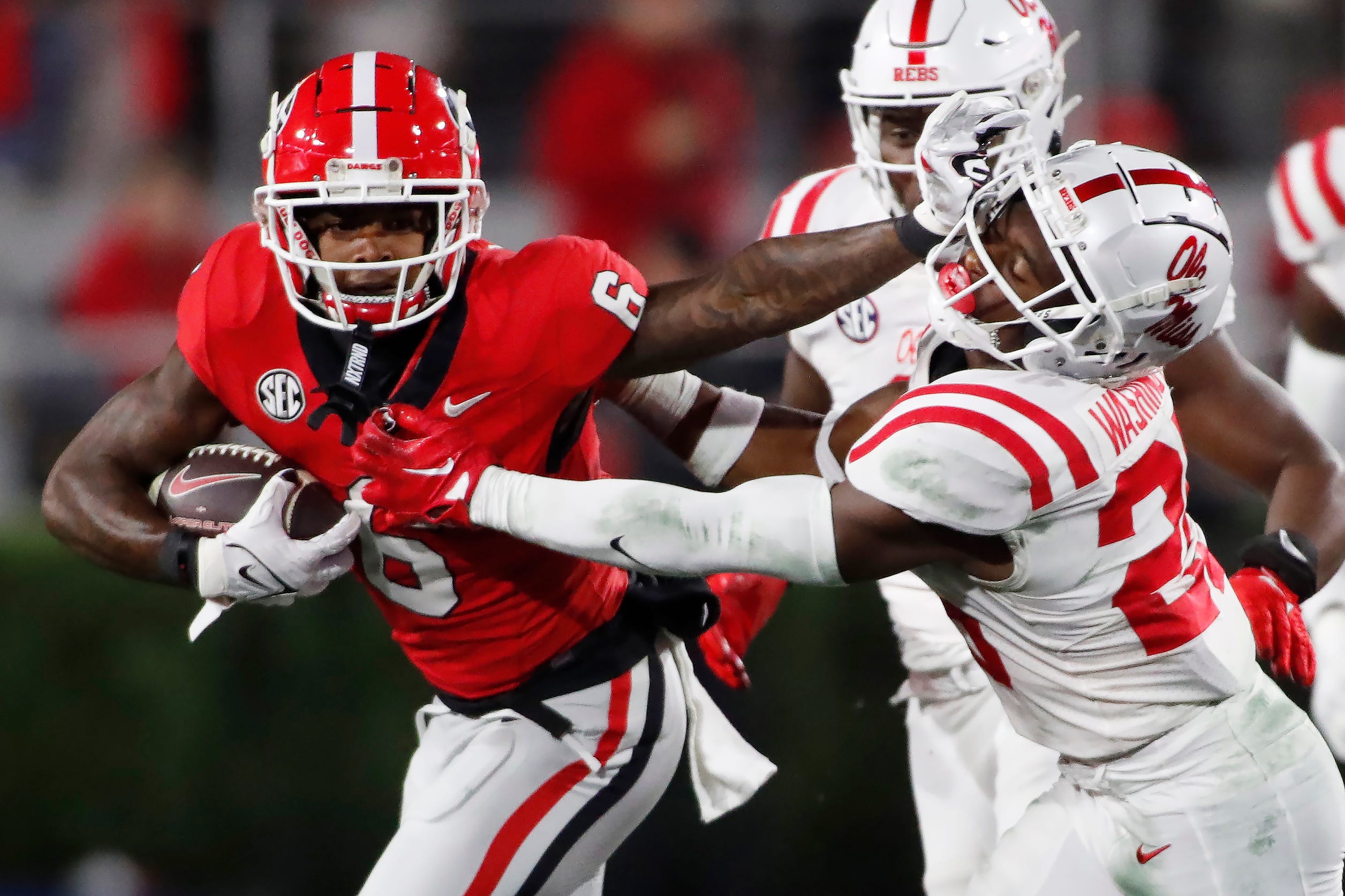 Georgia wide receiver Dominic Lovett (6) stiff arms Ole Miss safety Trey Washington (25) moves the ball during the first half of a NCAA college football game against Ole Miss in Athens, Ga., on Saturday
