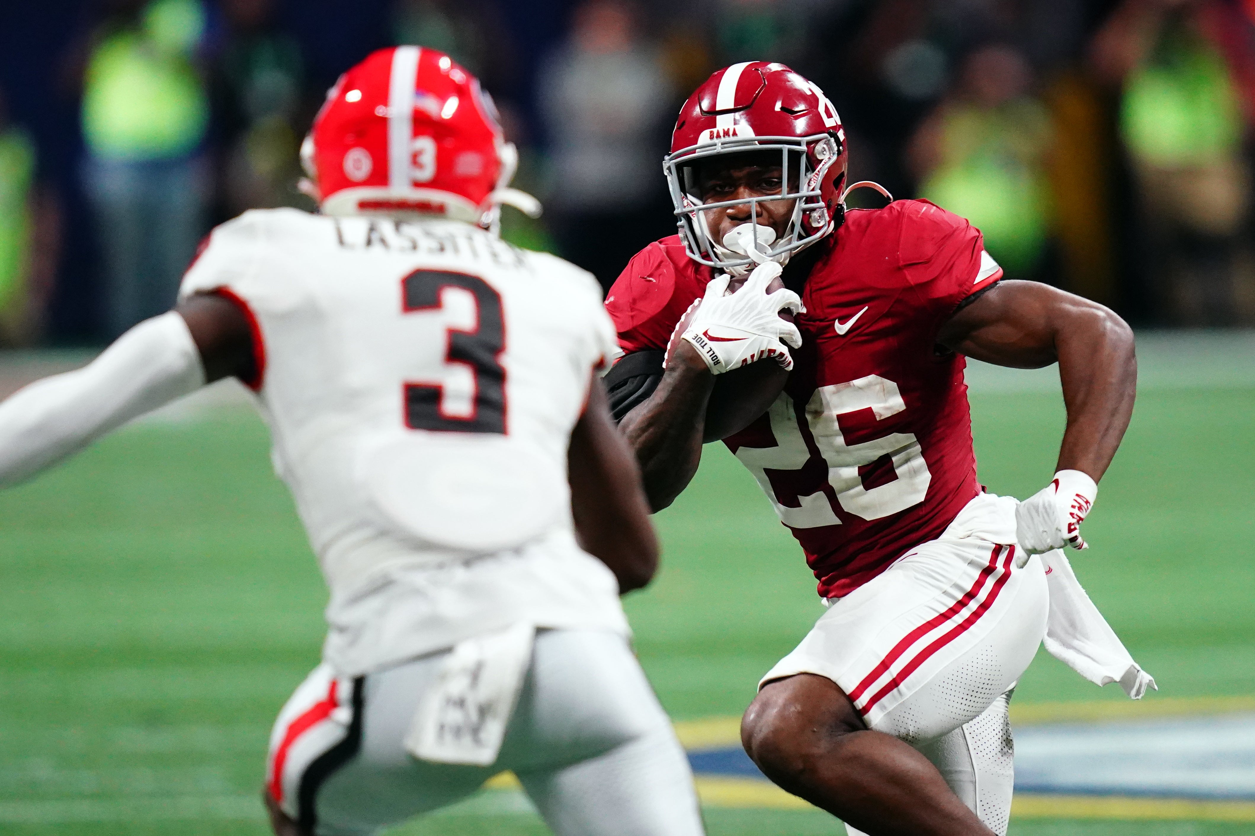 Dec 2, 2023; Atlanta, GA, USA; Alabama Crimson Tide running back Jam Miller (26) runs against Georgia Bulldogs defensive back Kamari Lassiter (3) in the fourth quarter of the SEC Championship at Mercedes-Benz Stadium. Mandatory Credit: John David Mercer-USA TODAY Sports  