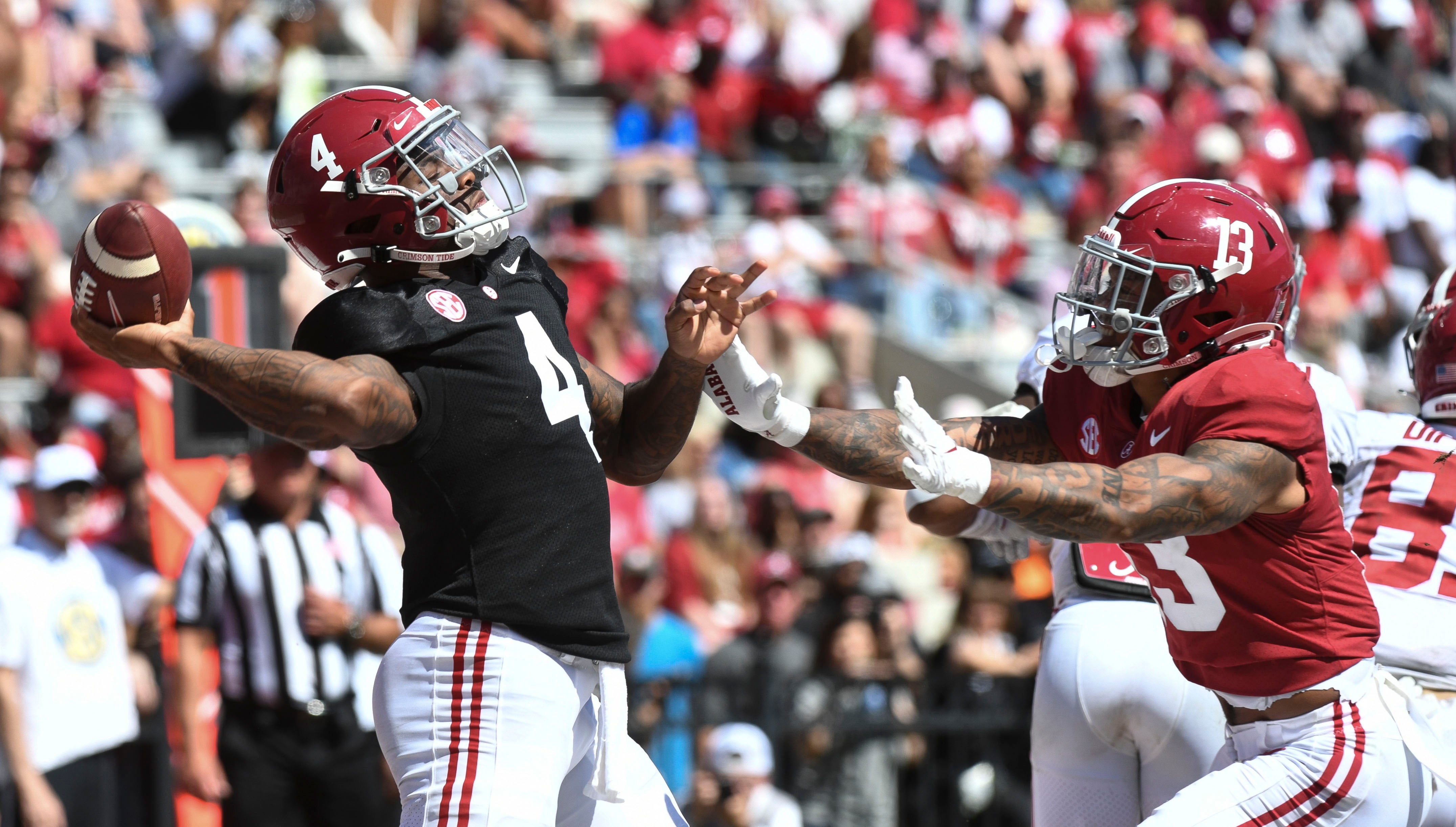 Apr 22, 2023; Tuscaloosa, AL, USA; White team quarterback Jalen Milroe (4) throws a pass as he is pressured by Crimson team defensive back Malachi Moore (13) at Bryant-Denny Stadium. Mandatory Credit: Gary Cosby-USA TODAY Sports  