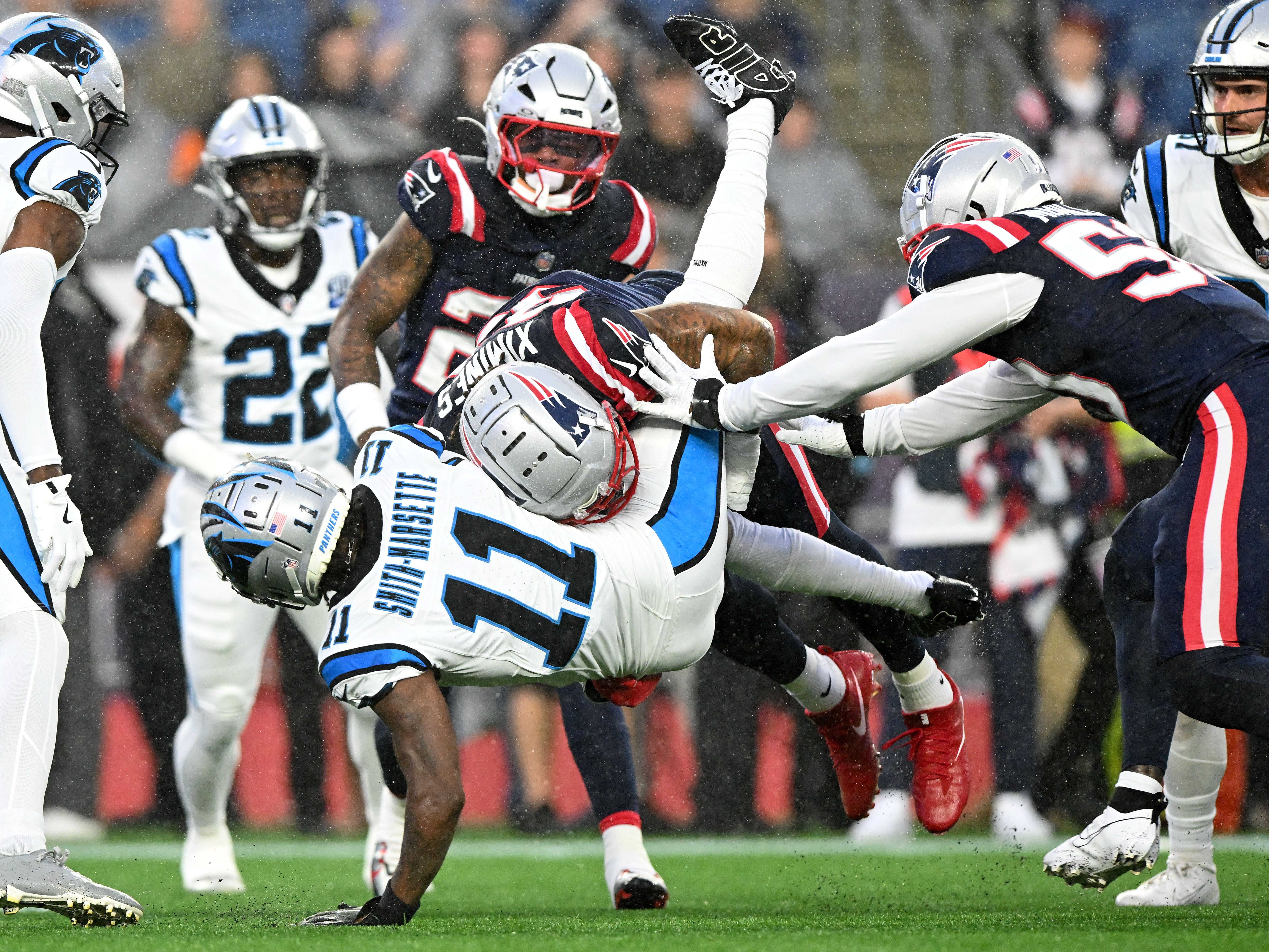 Aug 8, 2024; Foxborough, Massachusetts, USA; New England Patriots linebacker Oshane Ximines (93) tackles Carolina Panthers wide receiver Ihmir Smith-Marsette (11) during the first half at Gillette Stadium. Mandatory Credit: Brian Fluharty-USA TODAY Sports