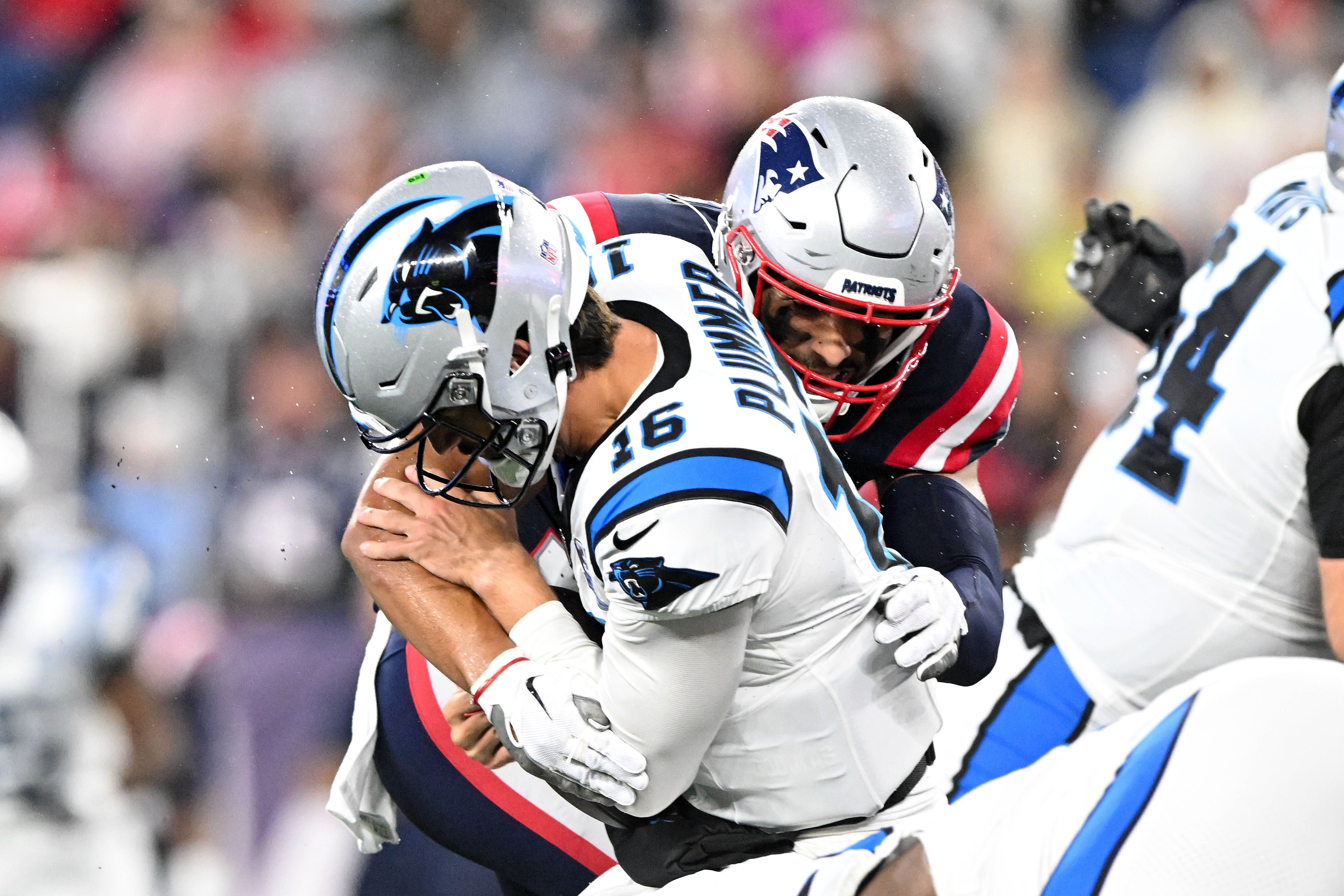 Aug 8, 2024; Foxborough, Massachusetts, USA; Carolina Panthers quarterback Jack Plummer (16) is sacked by New England Patriots linebacker Christian Elliss (53) during the first half at Gillette Stadium. Mandatory Credit: Brian Fluharty-USA TODAY Sports