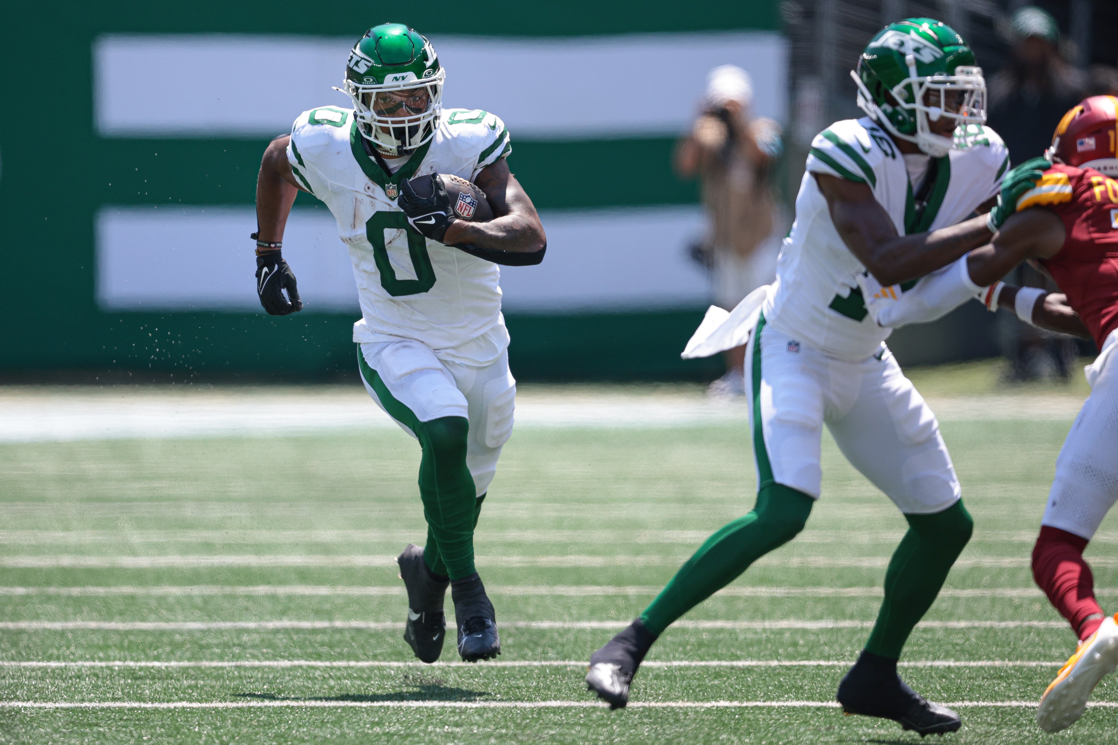 New York Jets running back Braelon Allen (0) carries the ball during the first half against the Washington Commanders at MetLife Stadium.