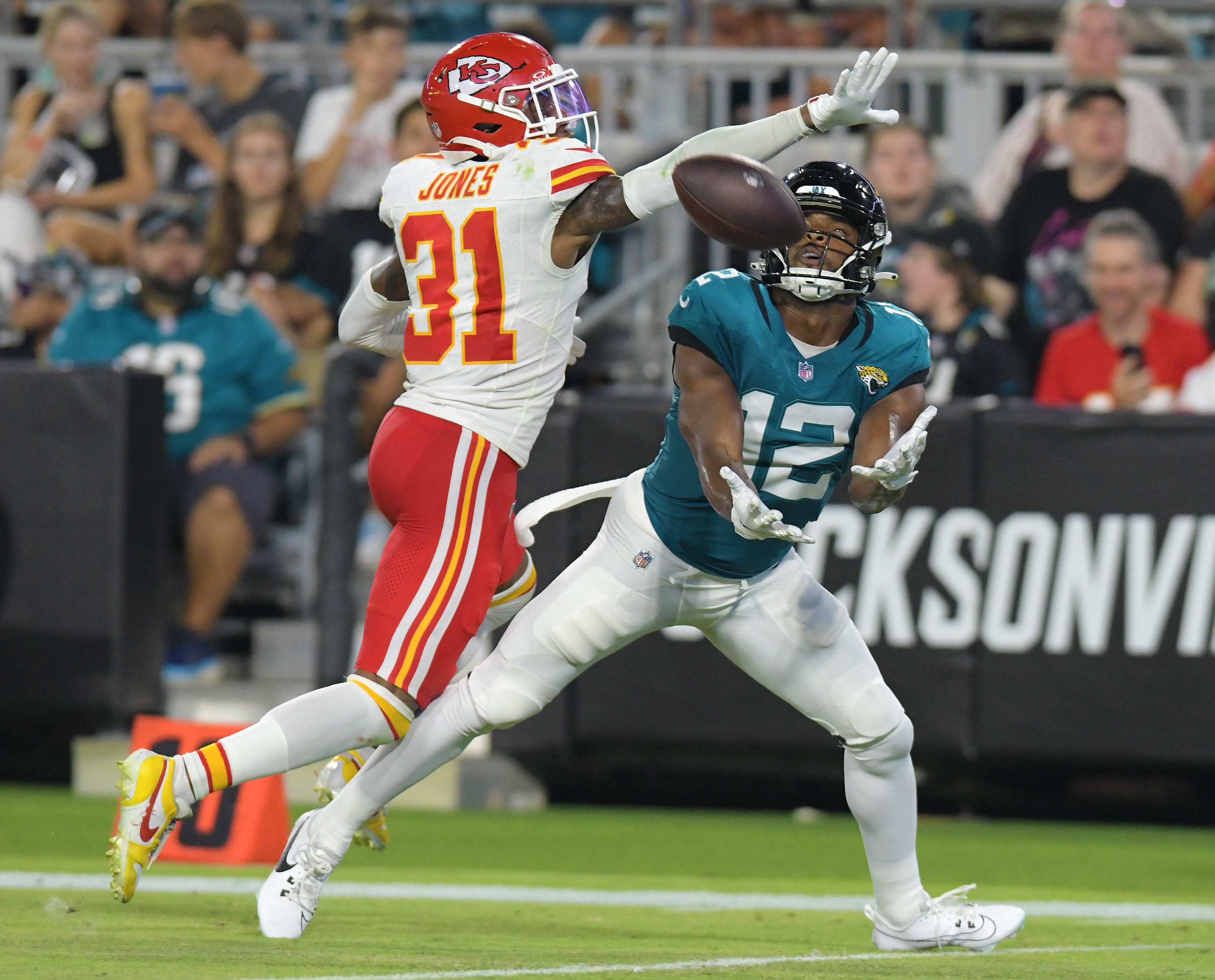 Jacksonville Jaguars wide receiver Devin Duvernay (12) pulls in a touchdown pass from Jacksonville Jaguars quarterback C.J. Beathard (3) late in the second quarter while being defended by Kansas City Chiefs cornerback Nic Jones (31). The Jaguars led 20 to 10 at the end of the first half. The Jacksonville Jaguars hosted the Kansas City Chiefs in the Jaguars first preseason game of the season Saturday, August10, 2024 at EverBank Stadium in Jacksonville, Fla.