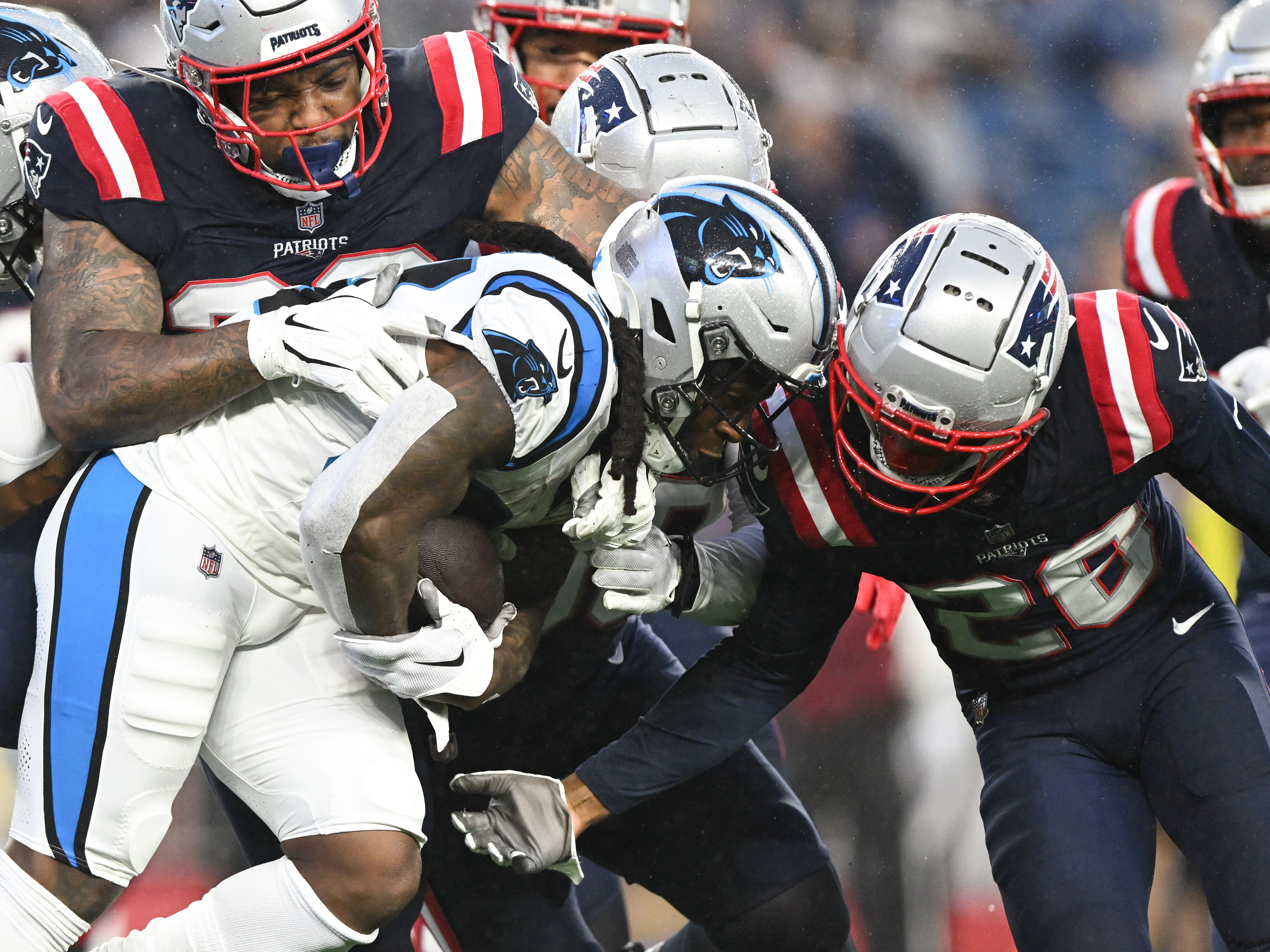 Aug 8, 2024; Foxborough, Massachusetts, USA; Carolina Panthers running back Mike Boone (34) rushes against New England Patriots cornerback Alex Austin (28) during the first half at Gillette Stadium. Mandatory Credit: Brian Fluharty-USA TODAY Sports