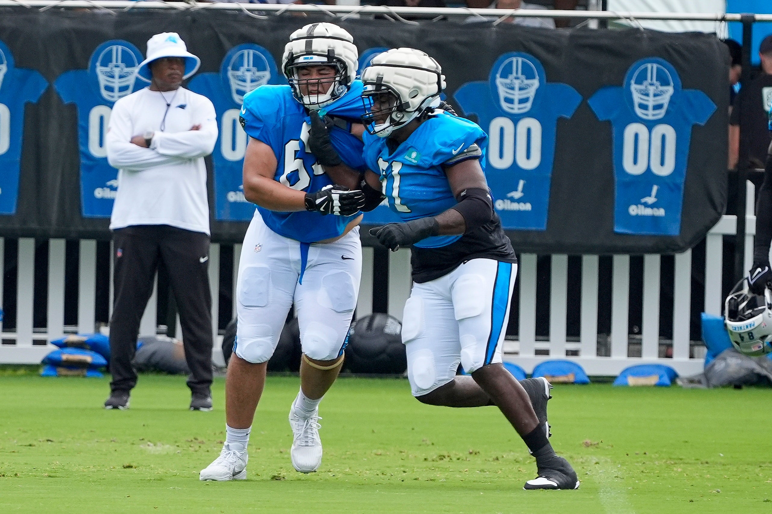 Jul 30, 2024; Charlotte, NC, USA; Carolina Panthers guard Damien Lewis (68) and offensive tackle Ricky Lee (61) drill during training camp at Carolina Panthers Practice Fields. Mandatory Credit: Jim Dedmon-USA TODAY Sports