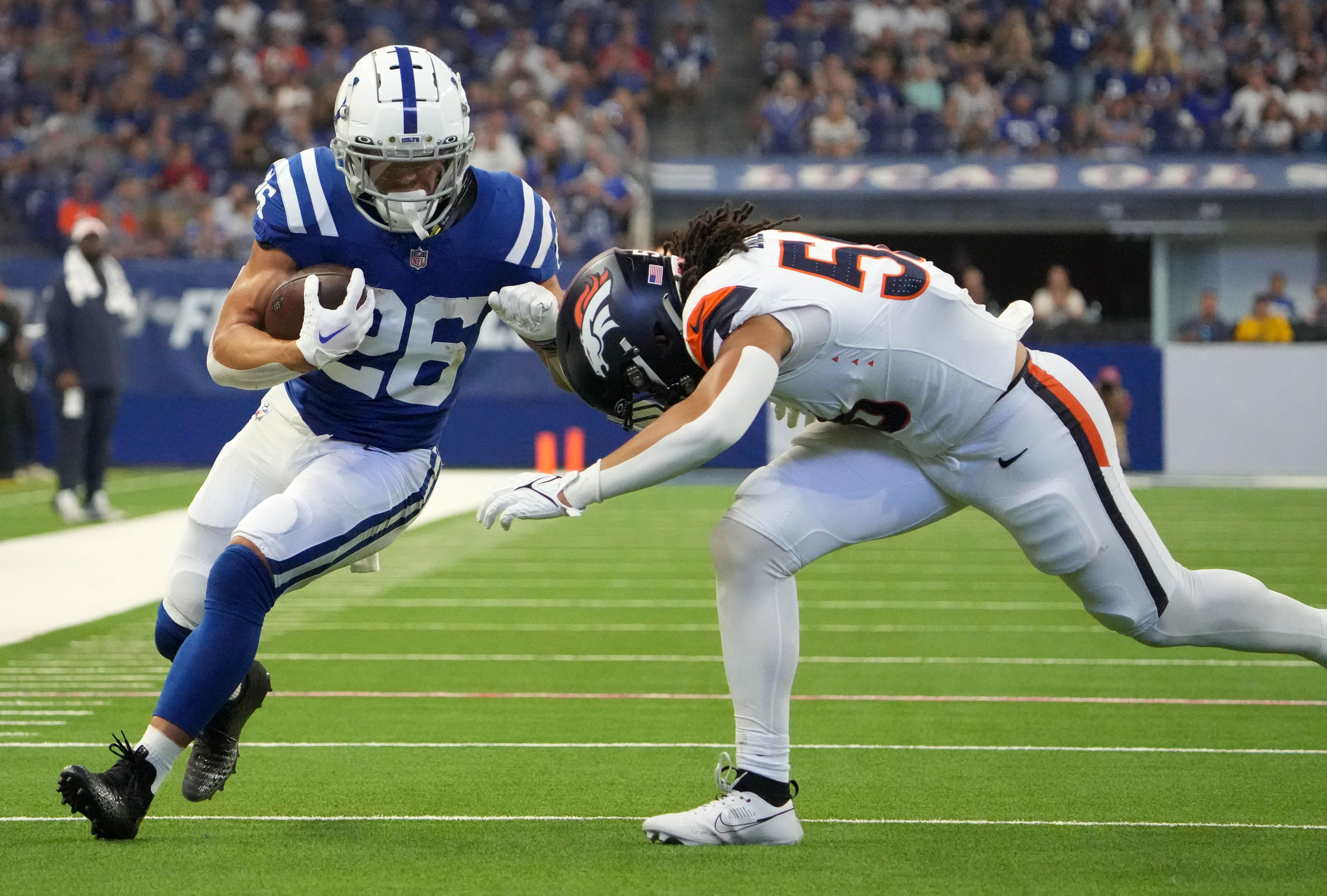 Denver Broncos linebacker Levelle Bailey (56) tackles Indianapolis Colts running back Evan Hull (26) during the first half of a preseason game Sunday, Aug. 11, 2024, at Lucas Oil Stadium in Indianapolis.