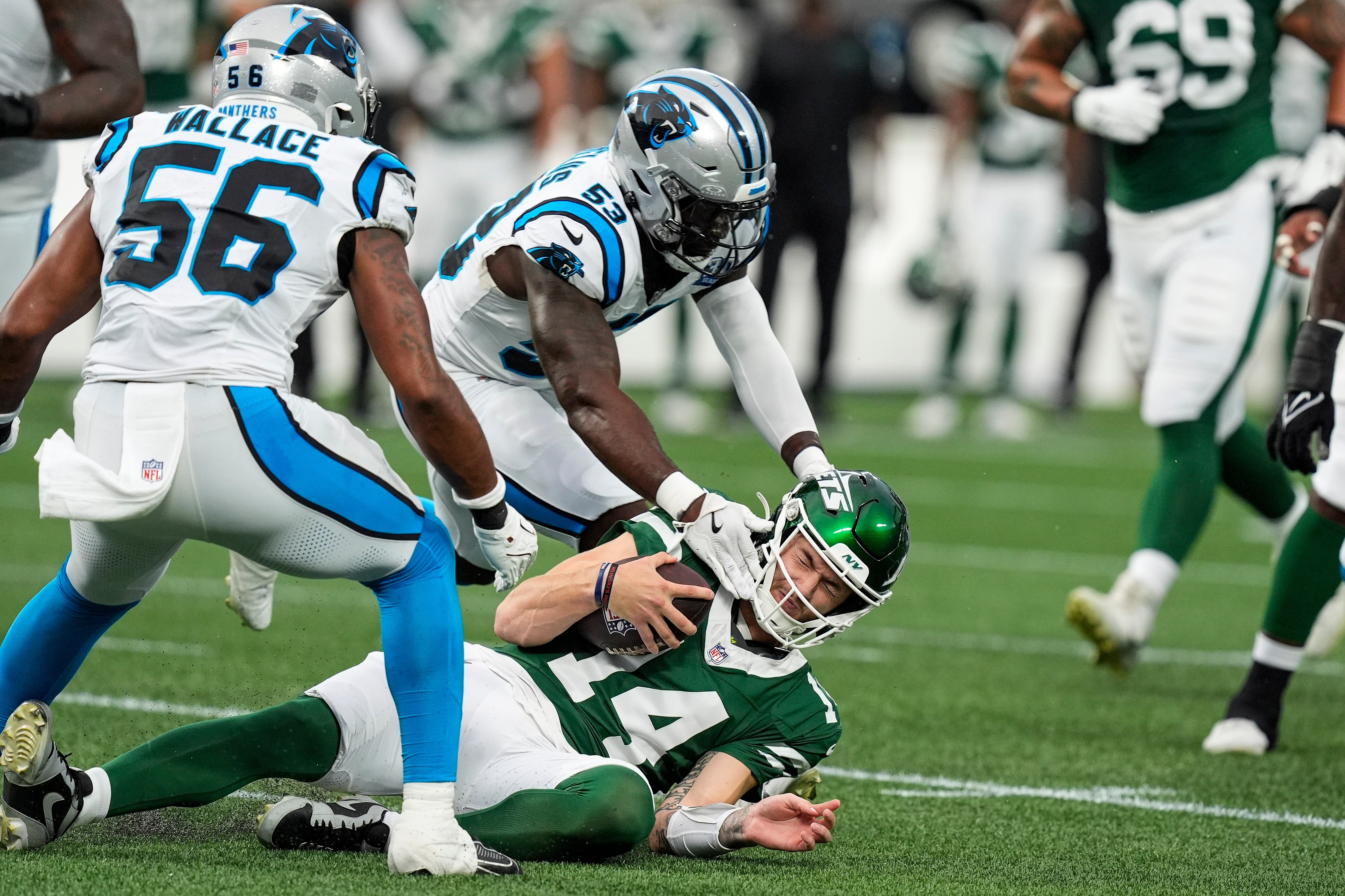Carolina Panthers linebacker Claudin Cherelus (53) tags New York Jets quarterback Andrew Peasley (14) during the first quarter at Bank of America Stadium.